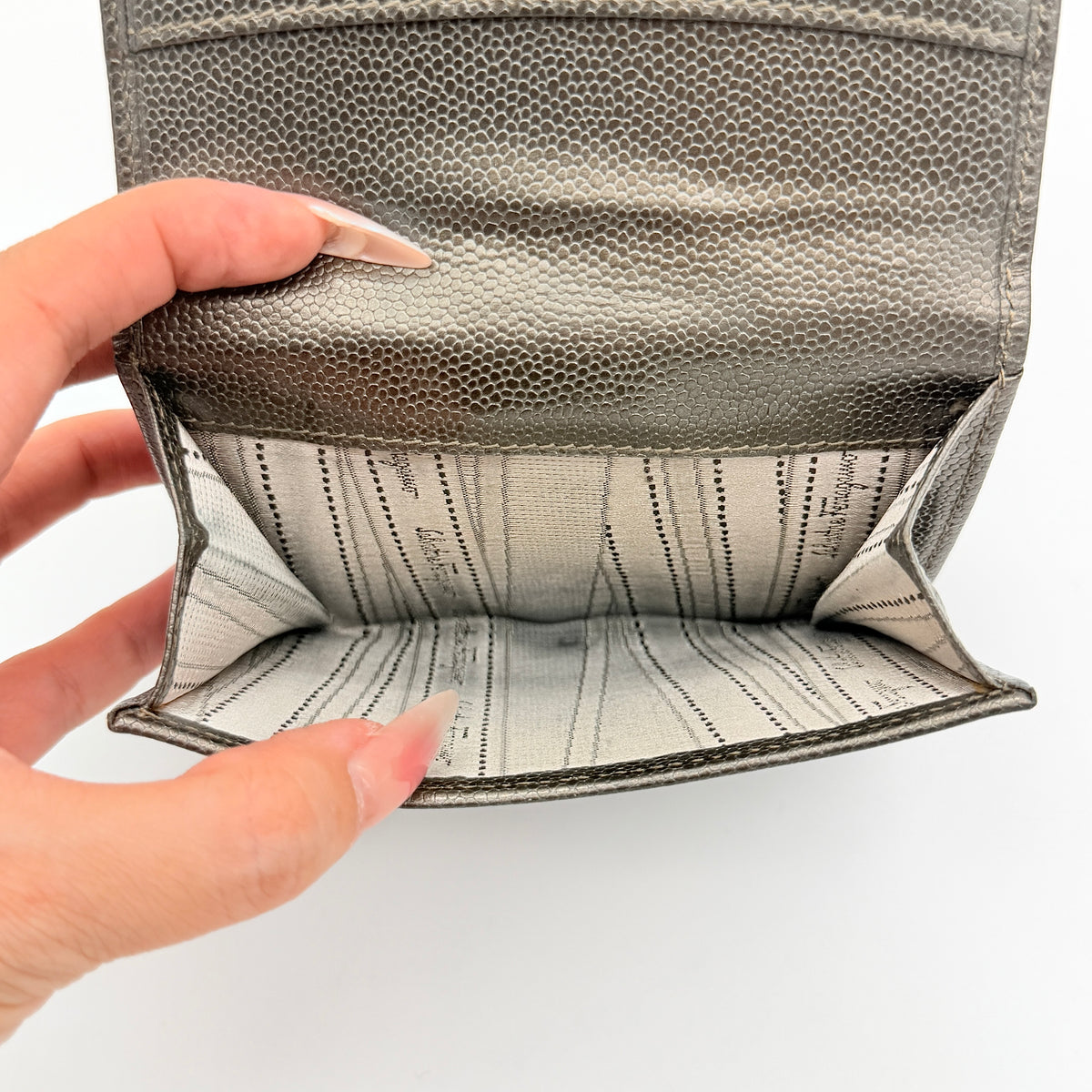 Salvatore Ferragamo Gancini Embossed Bifold Wallet in metallic grey textured leather, front view.