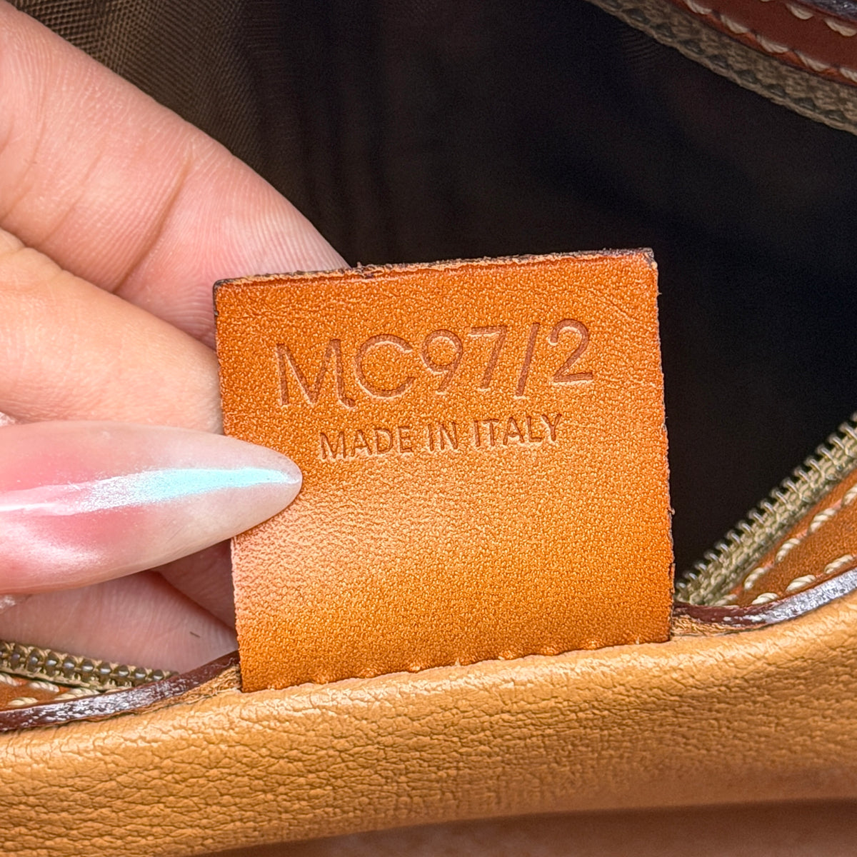 Front view of the Celine Triomphe Macadam Dome Handbag in brown, featuring the signature monogram canvas and tan leather details.