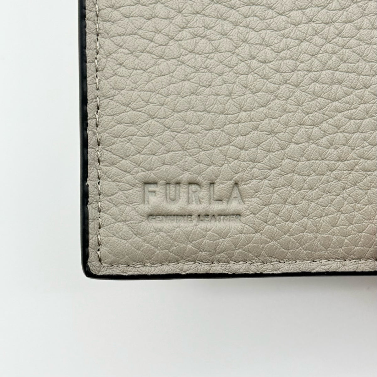 Furla Dafne Trifold Wallet in grey pebbled leather with gold-tone hardware and trifold interior, shown with original dust bag.