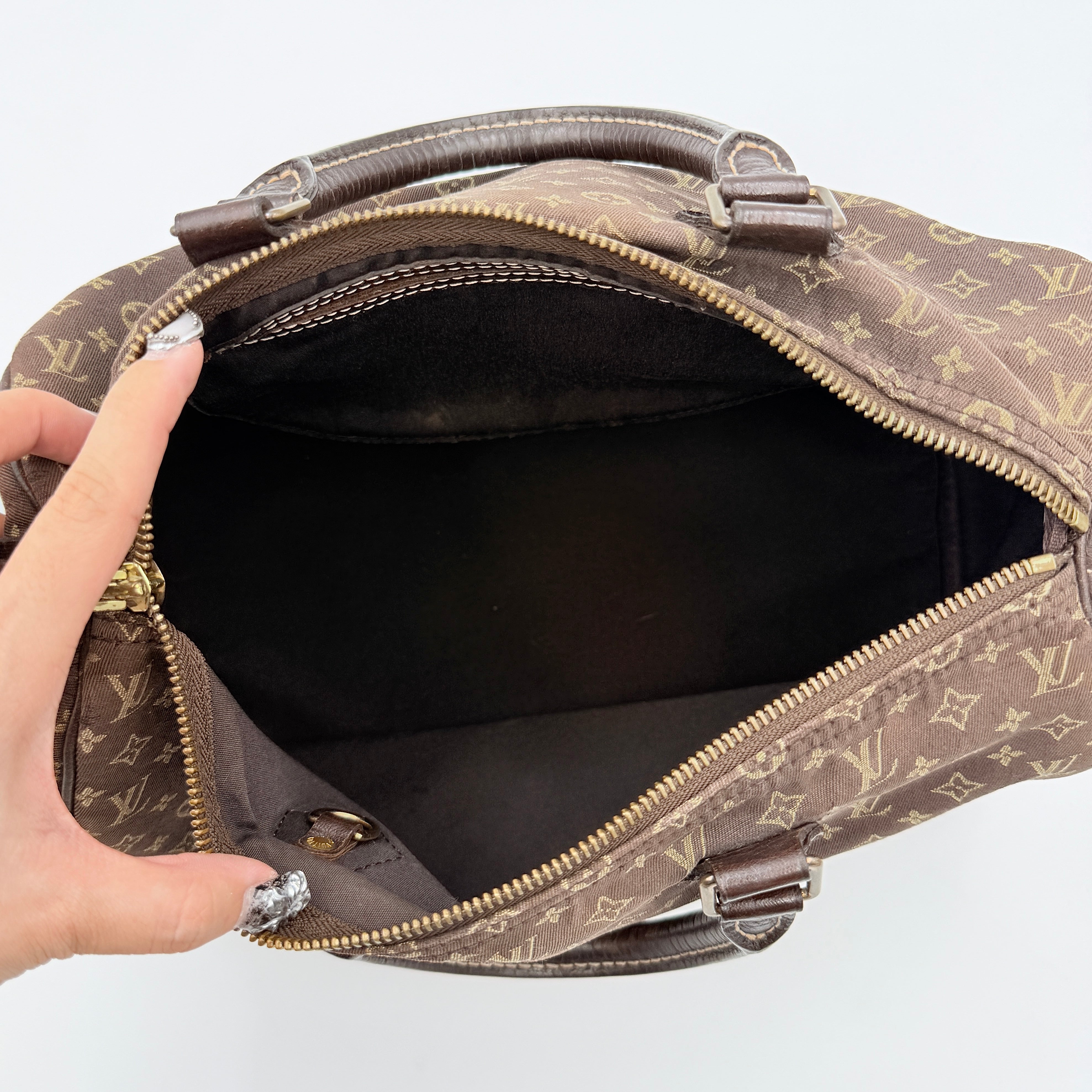 Louis Vuitton Monogram Mini Lin Speedy 30 in brown textile with top handles and monogram motif, shown against a white background.