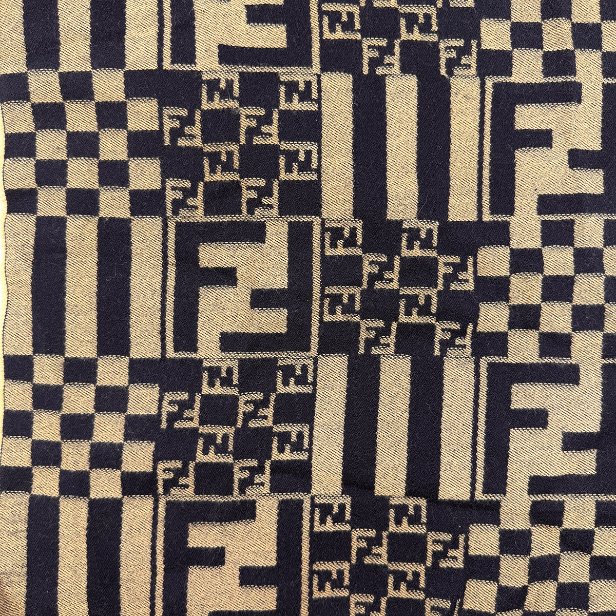 Fendi FF Zucca scarf in beige and black wool with checkered pattern and fringed edges, displayed flat.