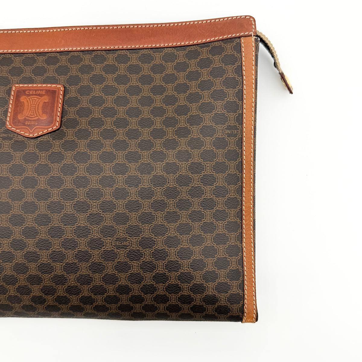 Celine Triomphe Macadam Clutch Bag in brown coated canvas with leather trim, shown against a white background.