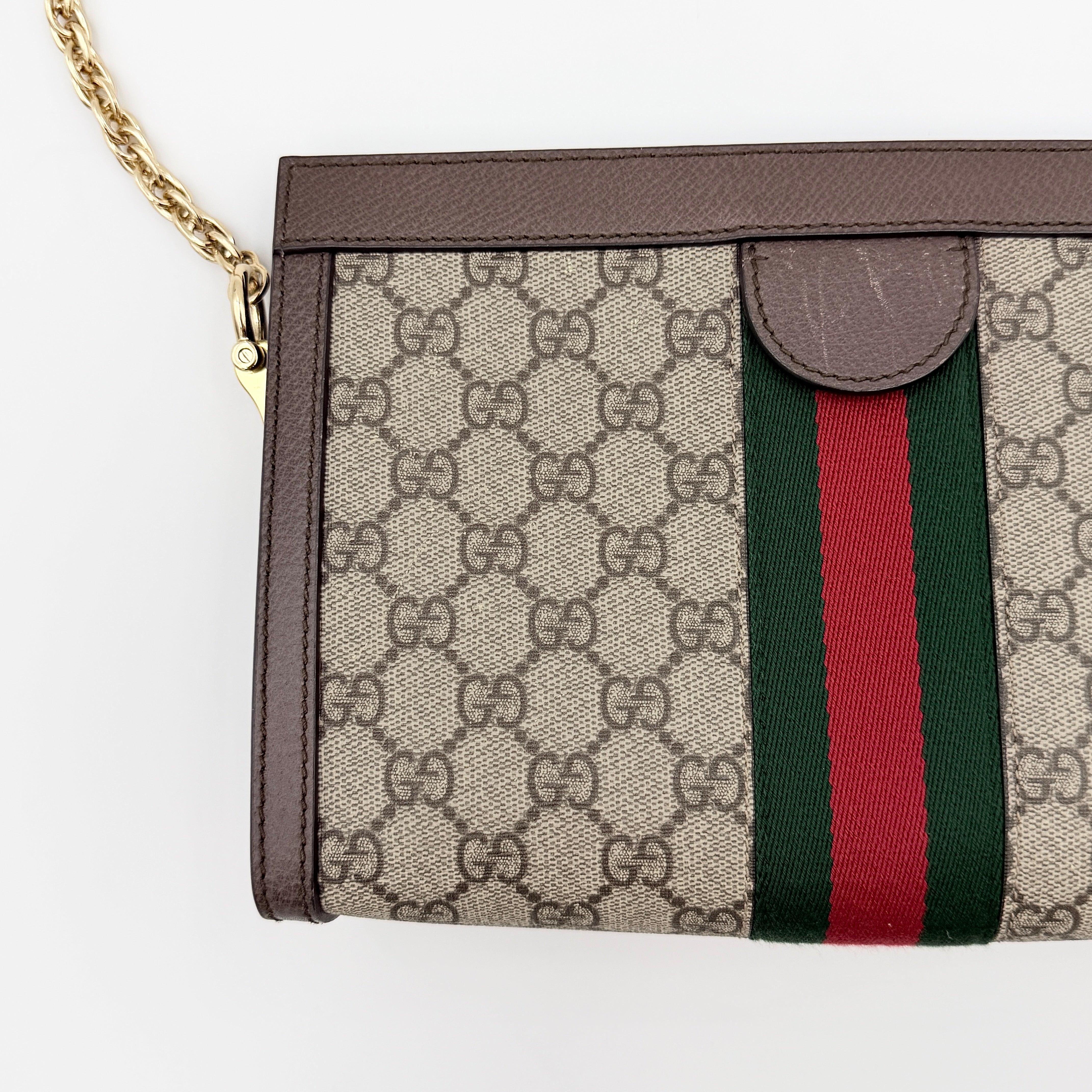 Gucci Ophidia GG Supreme crossbody bag in beige canvas with brown leather trim, signature web stripe, and gold chain strap.