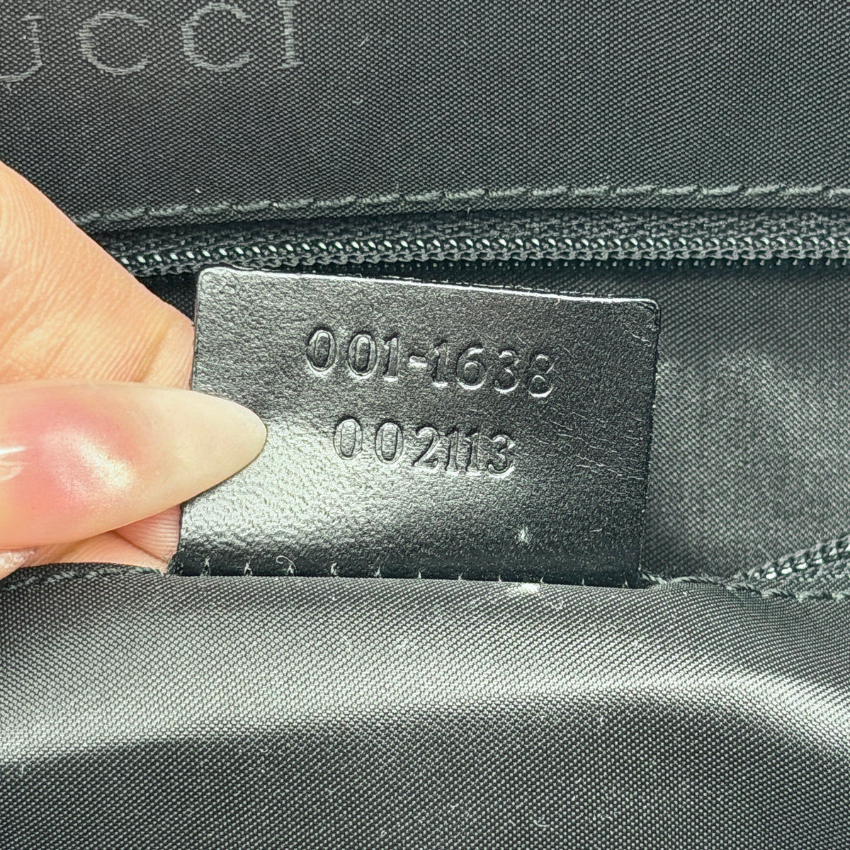 Gucci black nylon shoulder bag with bamboo handle and detachable strap shown with dust bag.