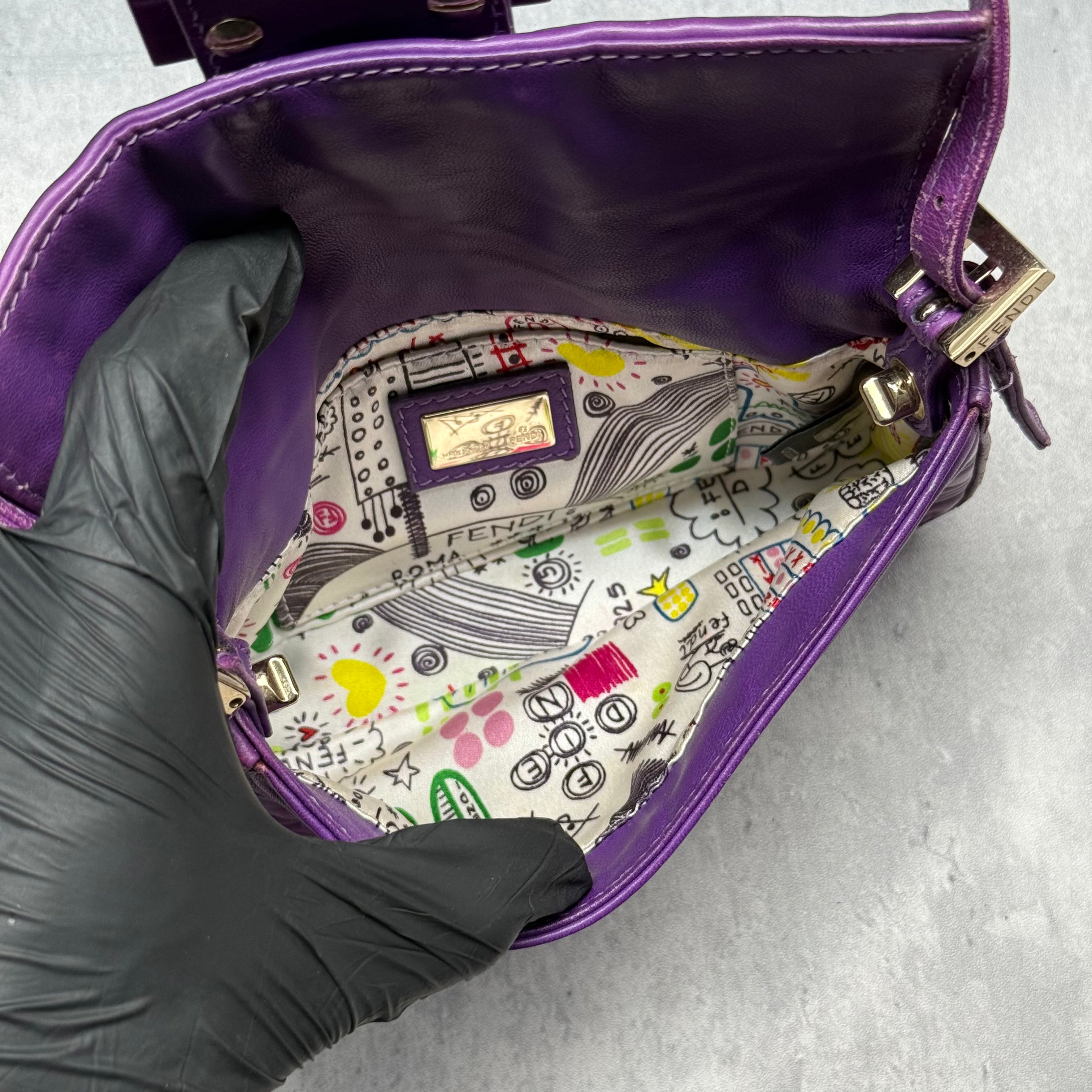 Fendi Baguette Shoulder Bag in purple embossed leather with silver FF buckle and multicolor interior lining.