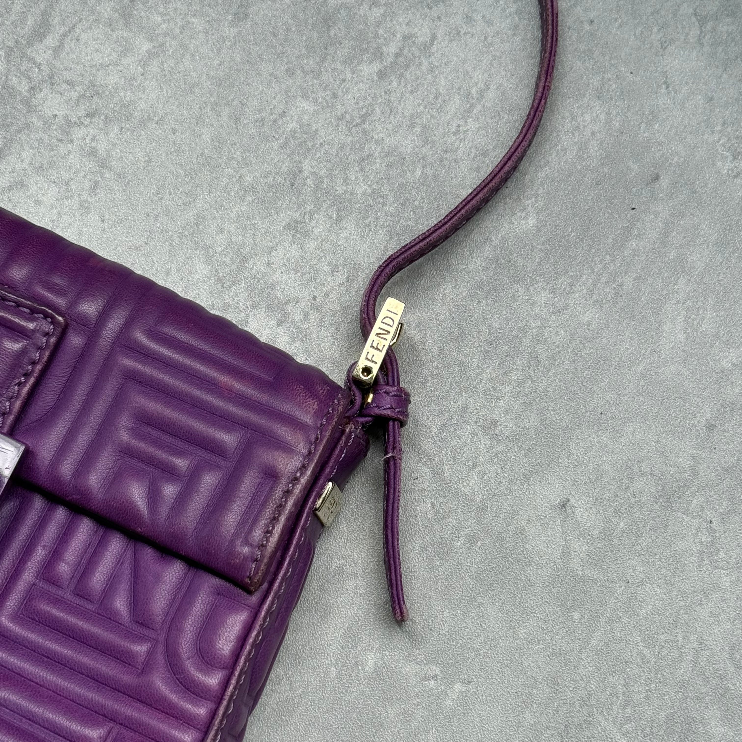 Fendi Baguette Shoulder Bag in purple embossed leather with silver FF buckle and multicolor interior lining.