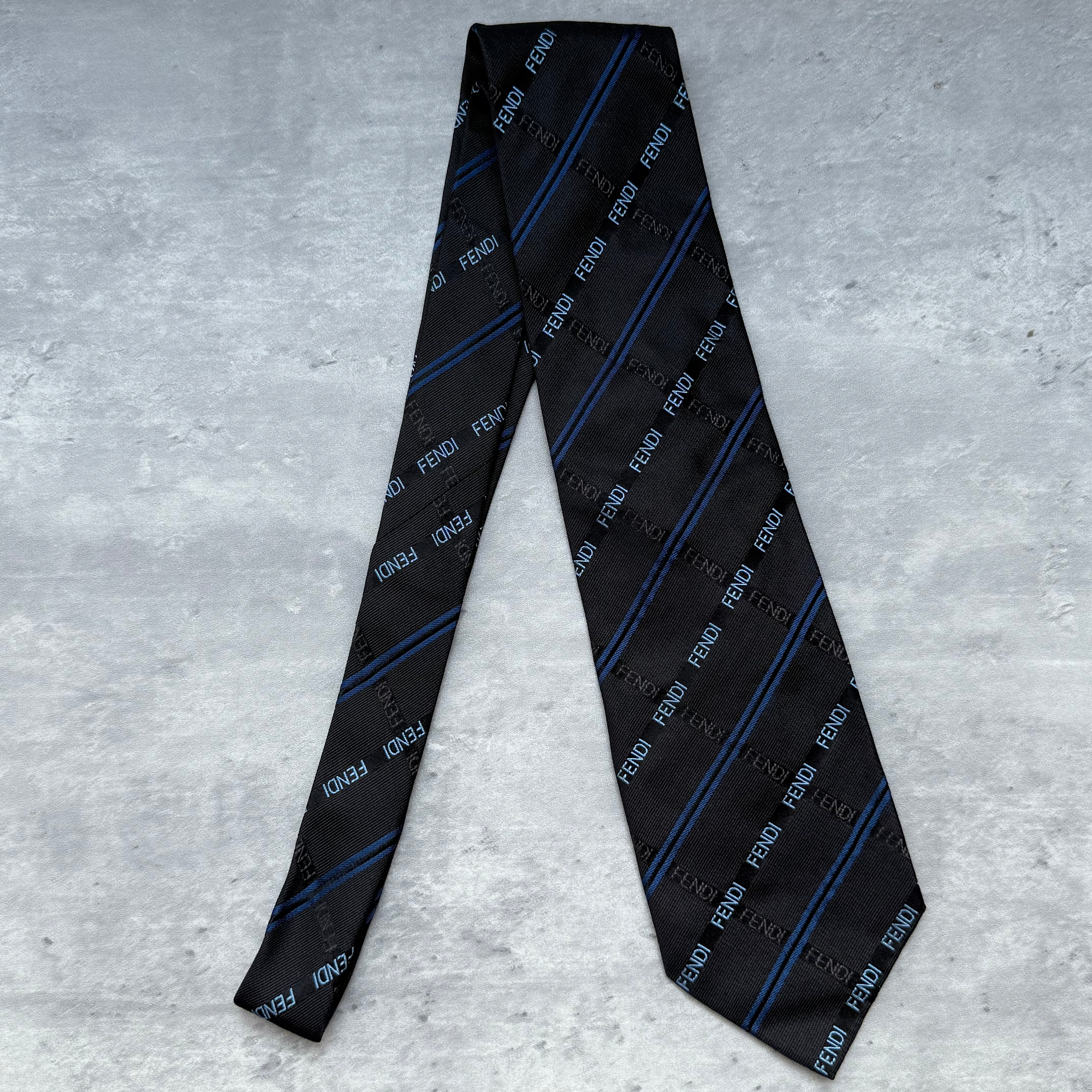 Fendi Monogram Stripes Silk Neck Tie in black with blue diagonal stripes, crafted in Italy from fine silk.