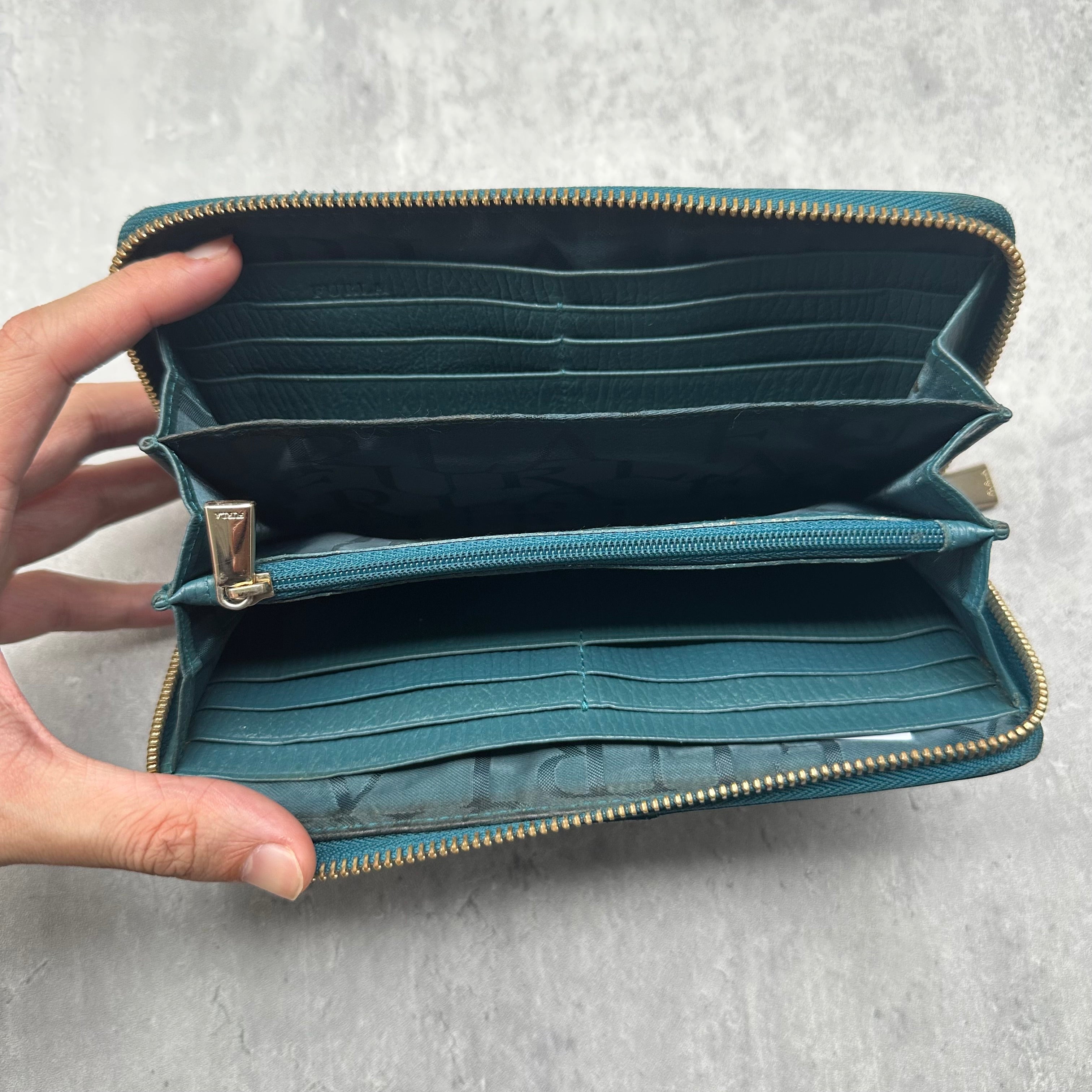 Furla Babylon Green Leather Zip Wallet with gold zipper and multiple card slots in a textured finish