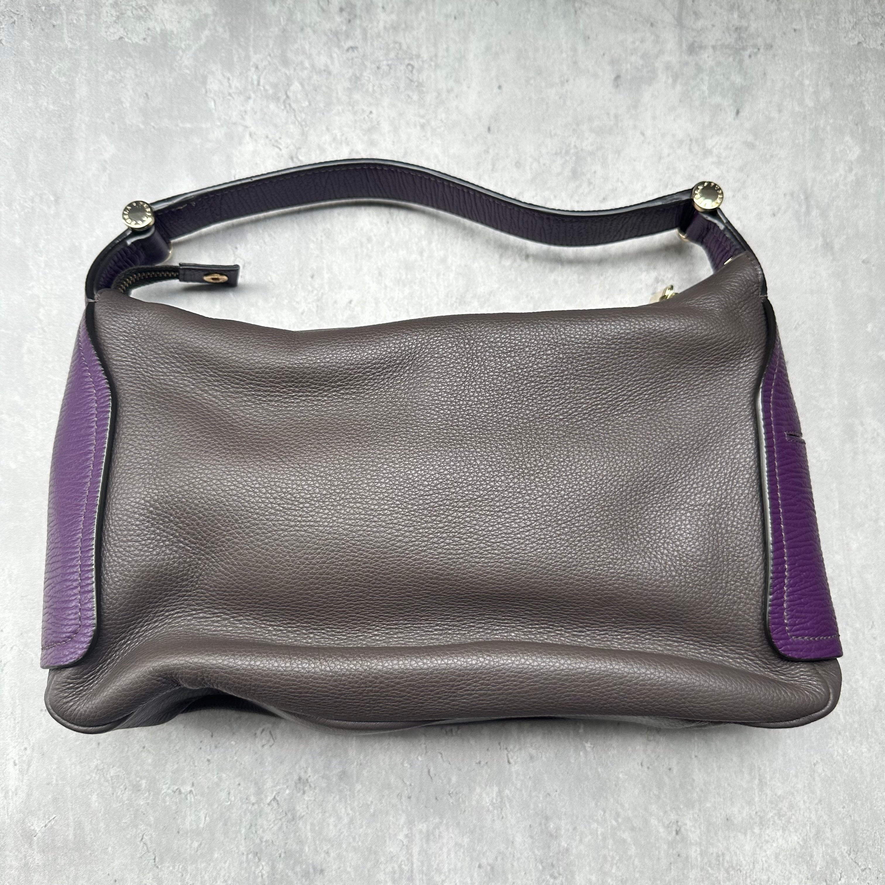 Furla Cindy Hobo Bag in brown pebbled leather with purple trim, gold zip closure, and logo-printed interior lining