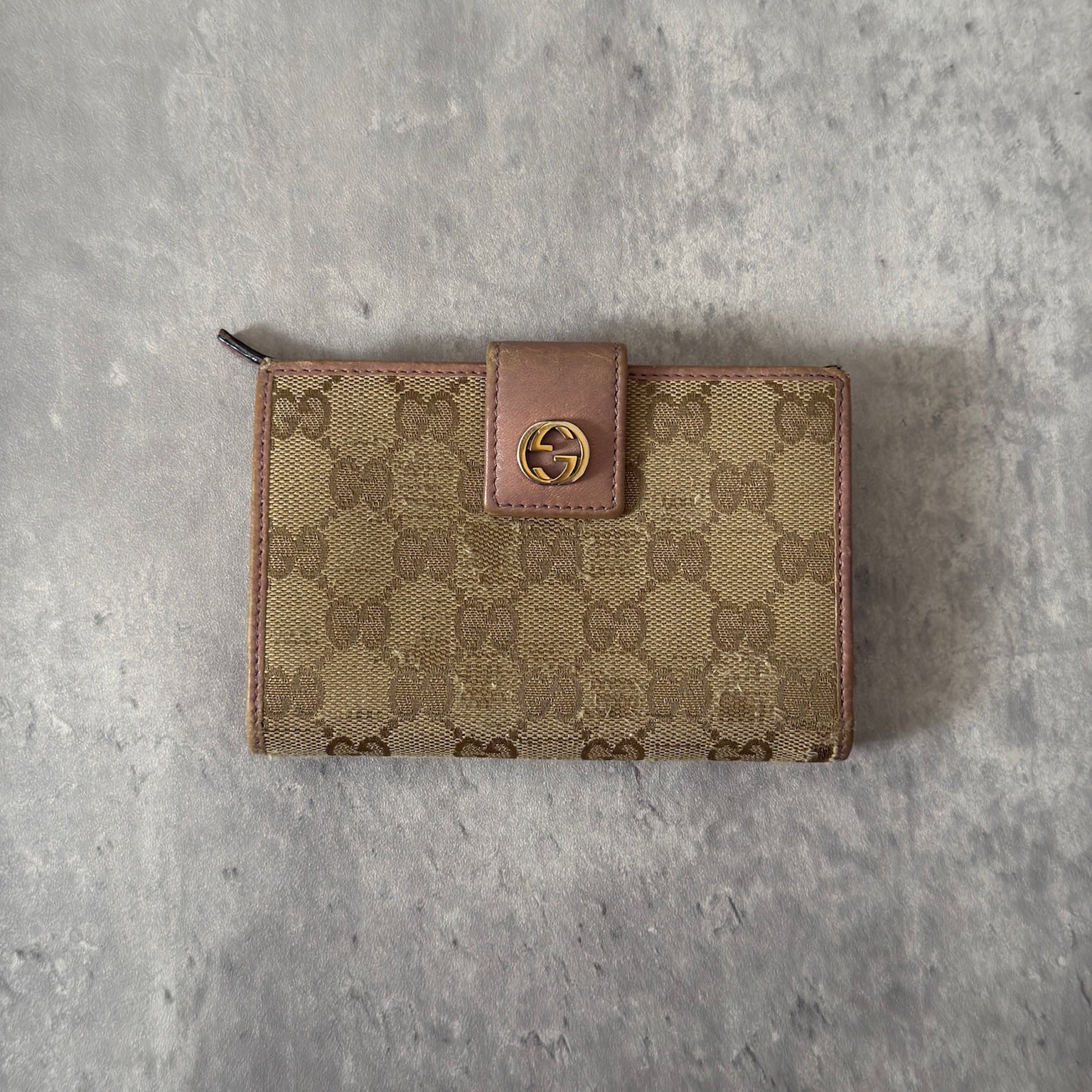 Gucci GG Logo Canvas Bifold Wallet in Pink/Beige with snap closure and multiple compartments, displaying minimal signs of wear.
