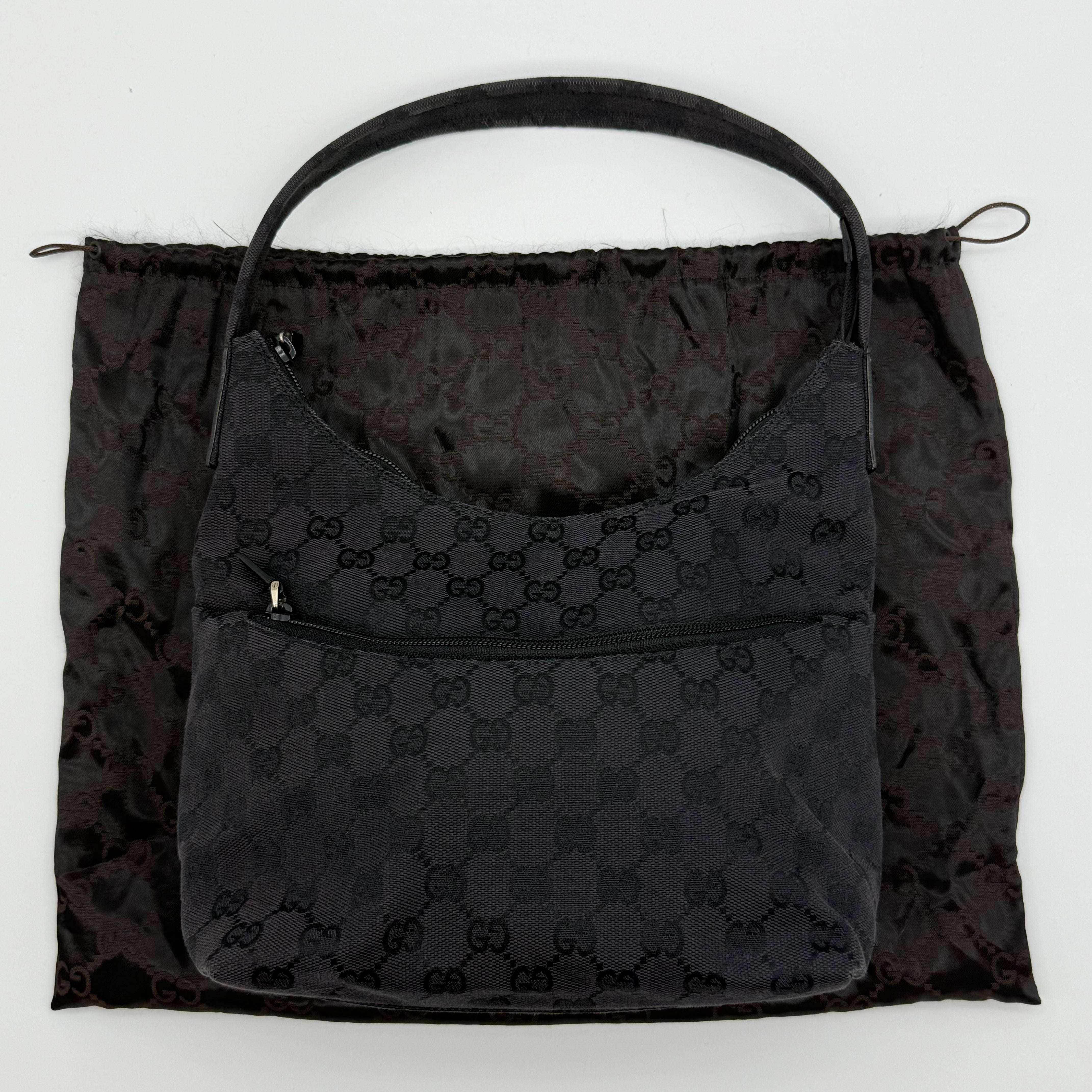Gucci GG Monogram hobo shoulder bag in black canvas with exterior zip pocket and zip-top closure — pre-loved.