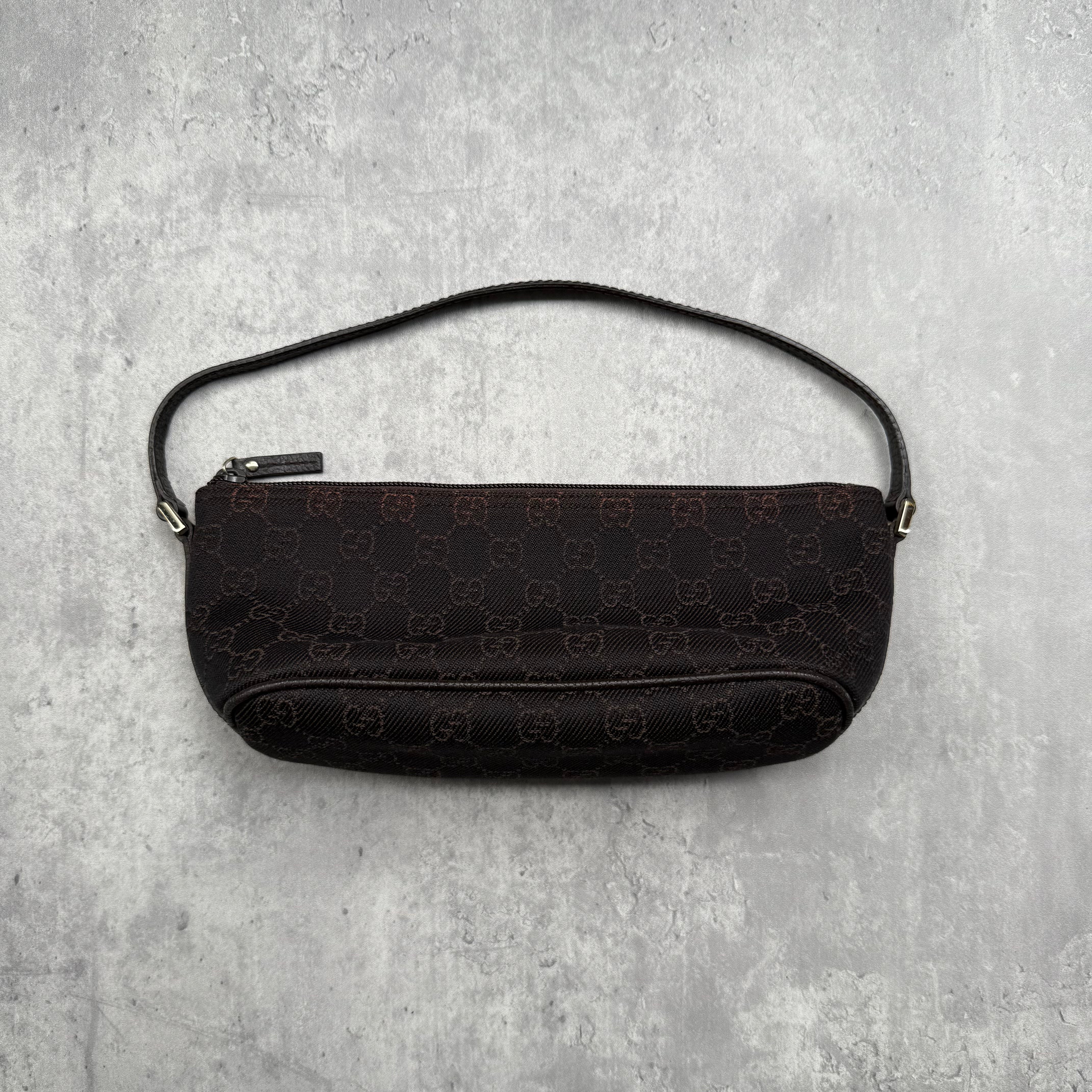 Gucci GG Monogram Pochette Boat Shoulder Bag in black canvas with tonal trim, top zip closure, and minimalist silhouette.