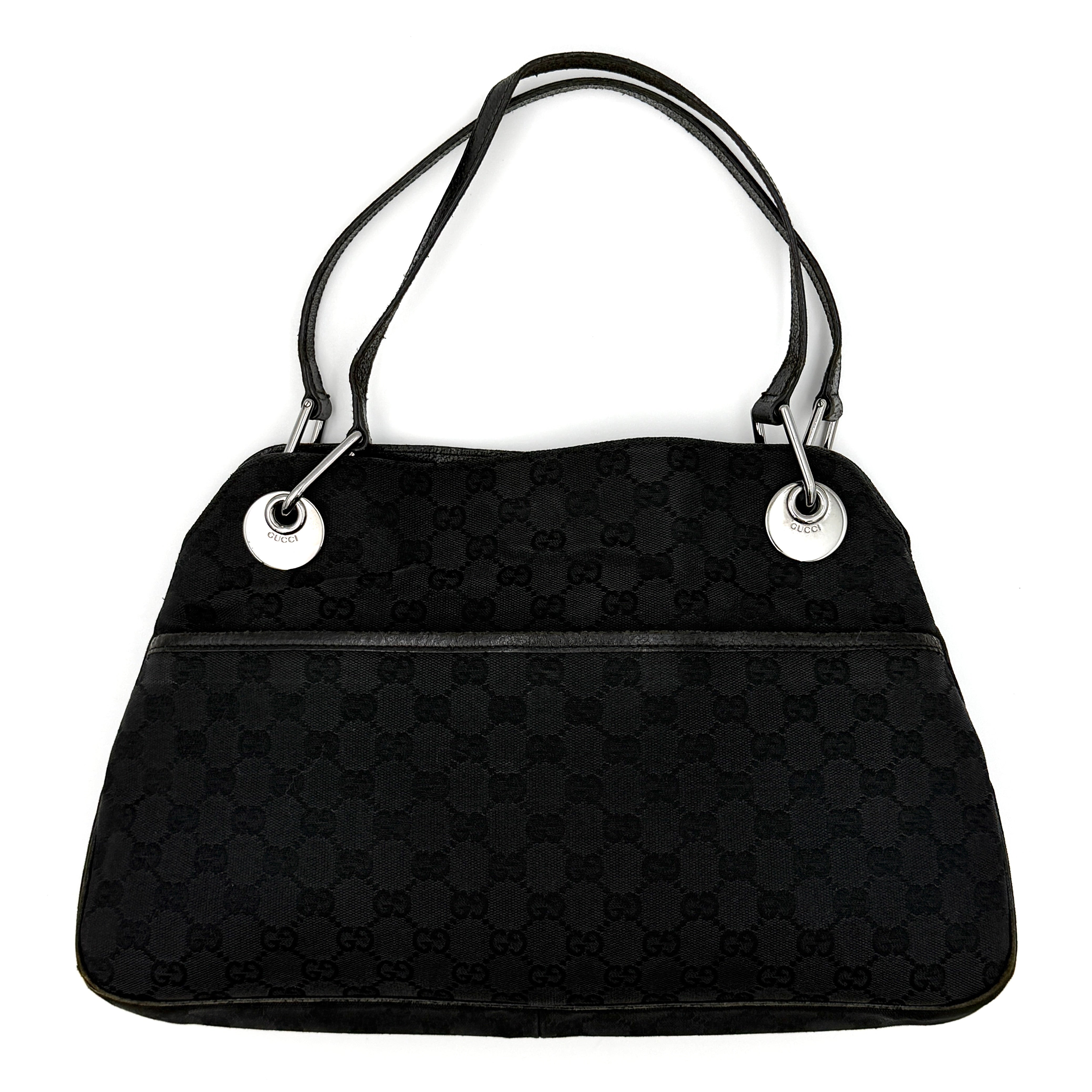 Gucci GG Monogram Shoulder Bag in black canvas with leather trim, silver-tone grommets, and spacious interior.
