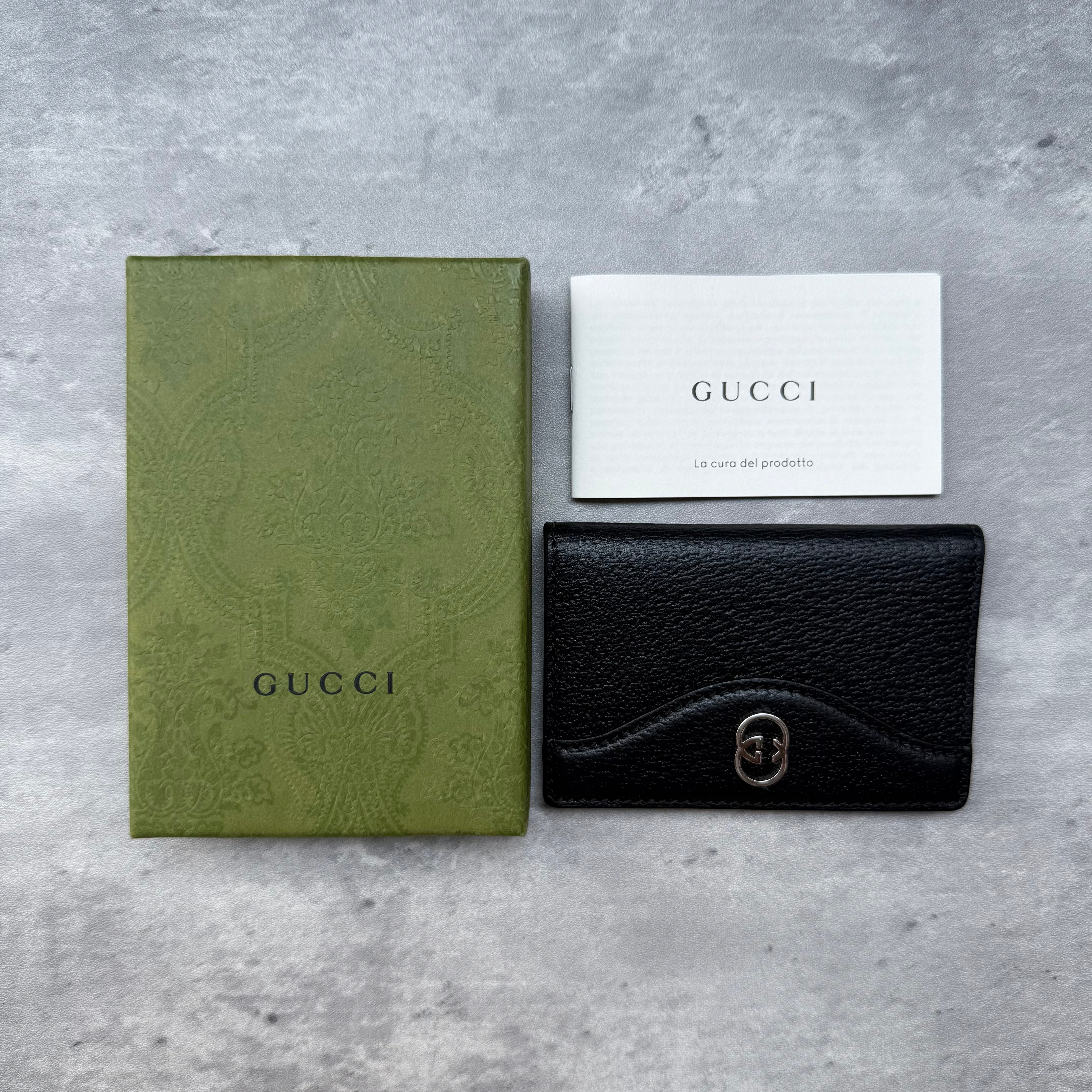 Gucci Interlocking G Cardholder in black pebbled leather with silver-tone logo, displayed with original Gucci box and authenticity card.