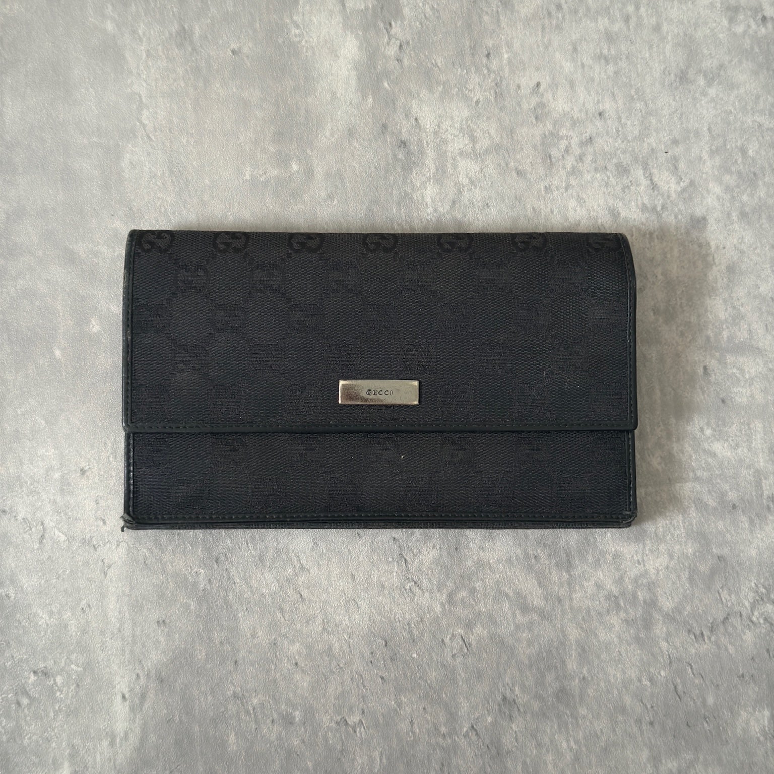 Gucci Monogram Black Bifold Long Wallet with snap-button closure and multiple compartments.