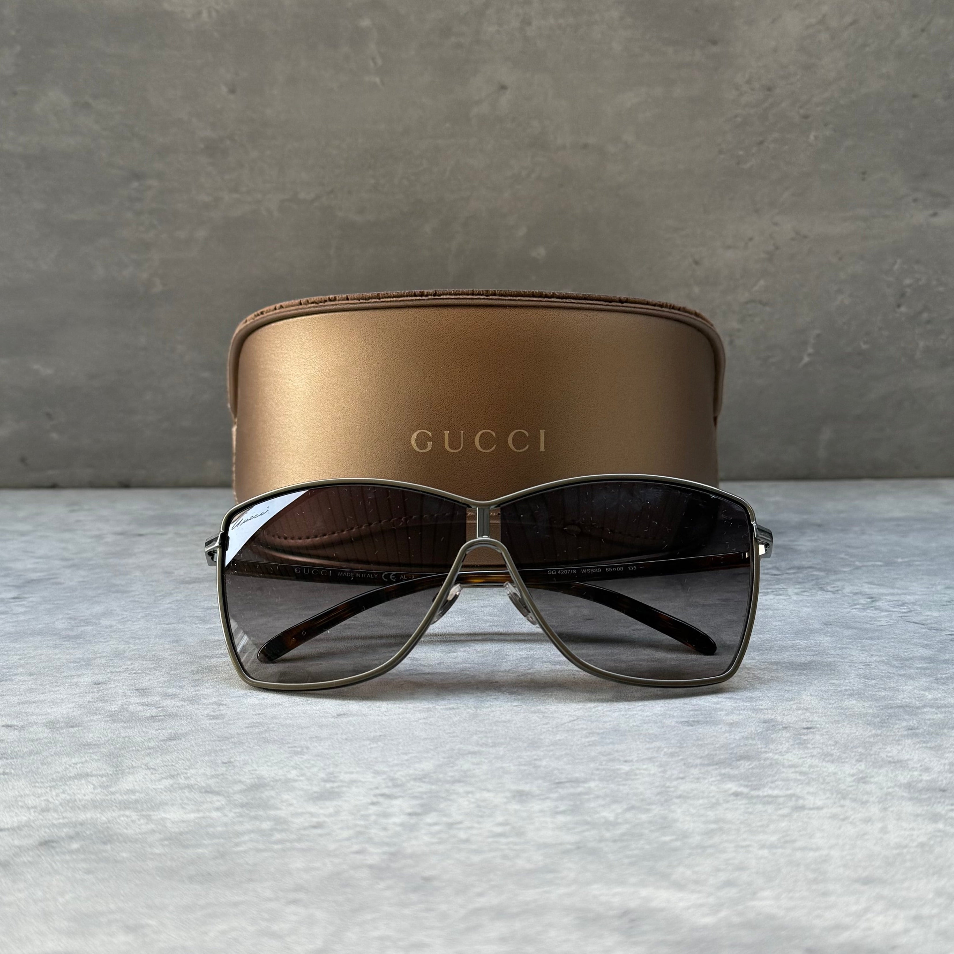 Gucci Oversized Square Brown Sunglasses with silver-tone metal frame, tortoiseshell temples, and gradient brown lenses.