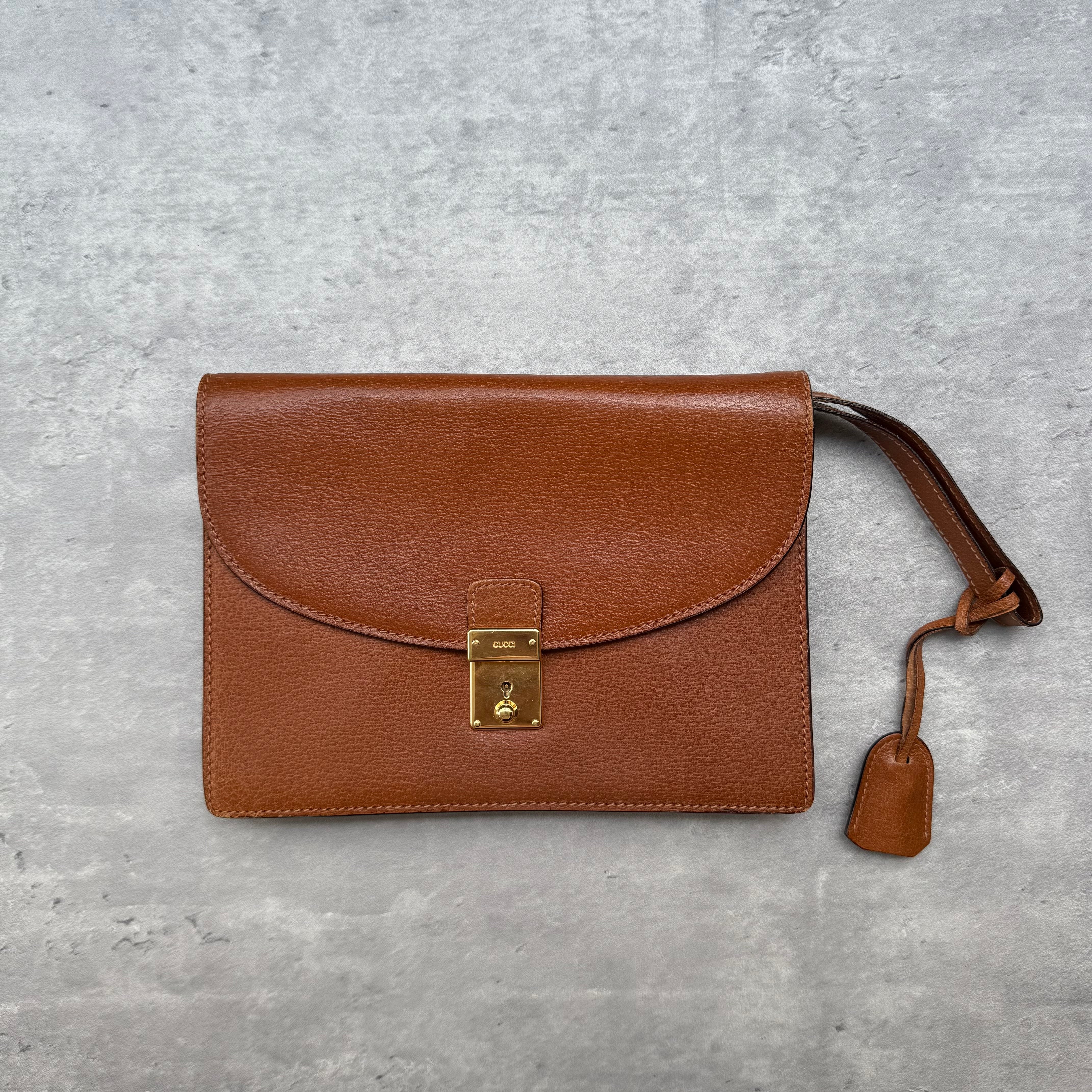 Gucci Vintage Brown Leather Clutch Bag with gold-tone lock closure and suede-lined interior