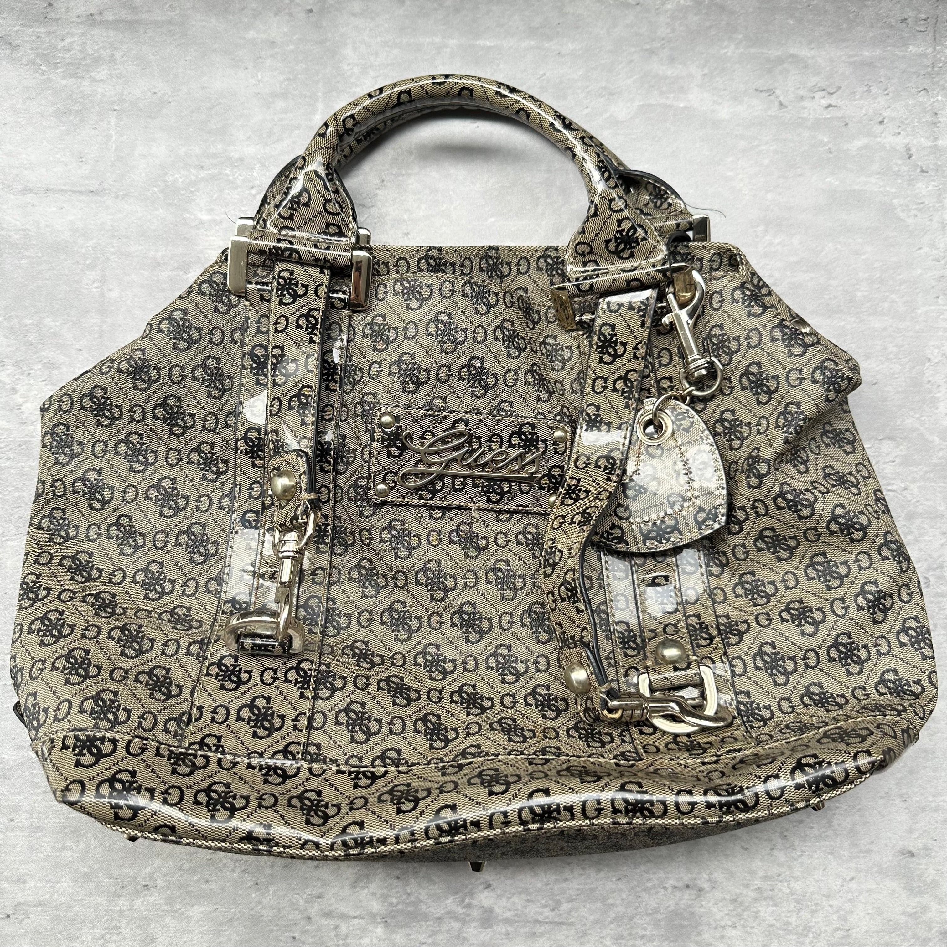 Guess Faux Fur Crossbody Bag, featuring monogram logo print in taupe faux leather with silver-tone hardware, patent trim, and heart-print interior lining.