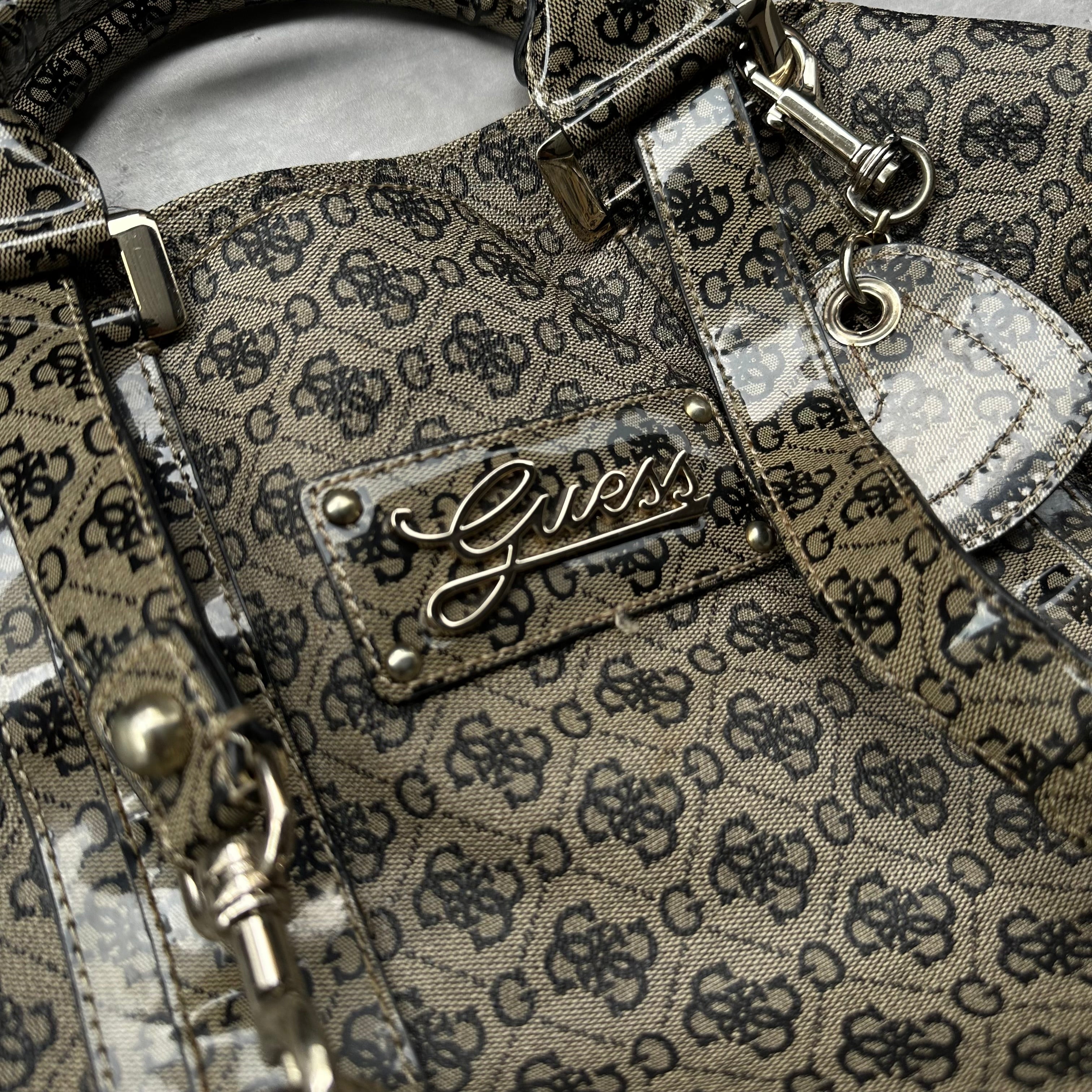 Guess Faux Fur Crossbody Bag, featuring monogram logo print in taupe faux leather with silver-tone hardware, patent trim, and heart-print interior lining.