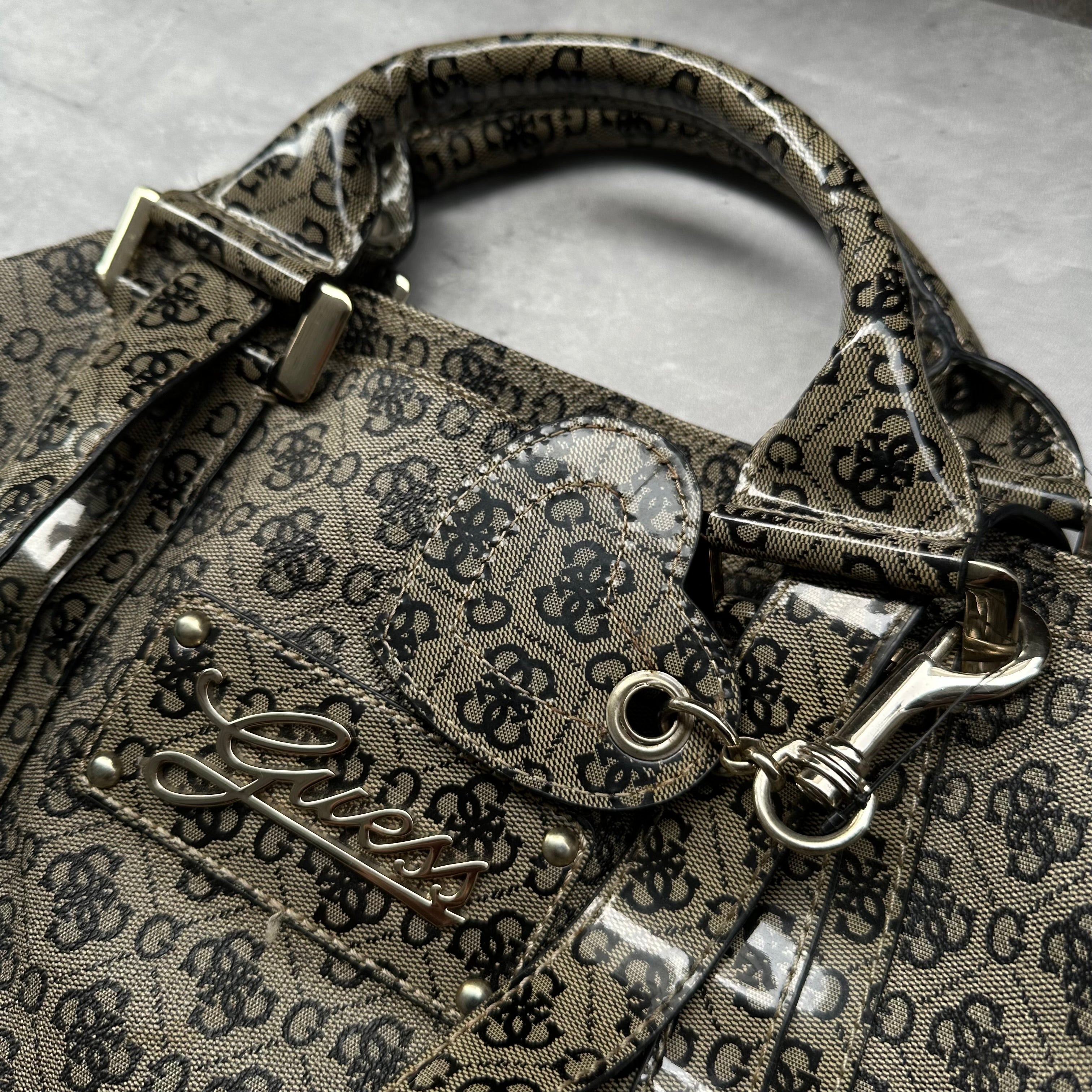 Guess Faux Fur Crossbody Bag, featuring monogram logo print in taupe faux leather with silver-tone hardware, patent trim, and heart-print interior lining.