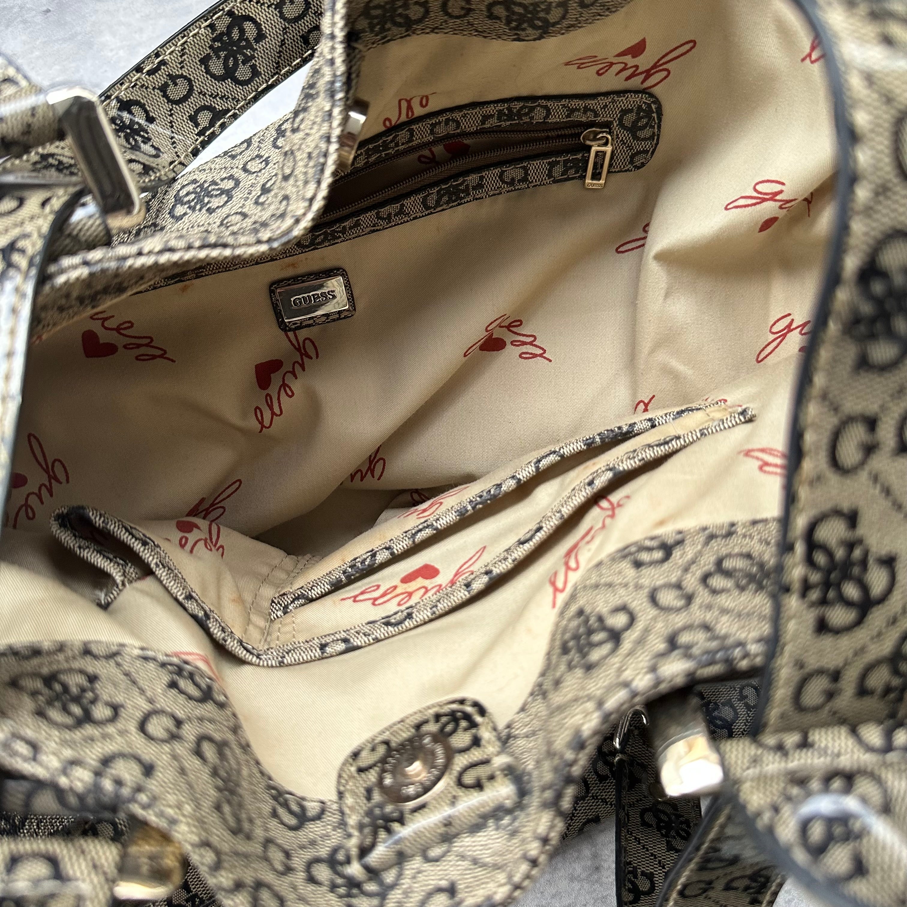 Guess Faux Fur Crossbody Bag, featuring monogram logo print in taupe faux leather with silver-tone hardware, patent trim, and heart-print interior lining.