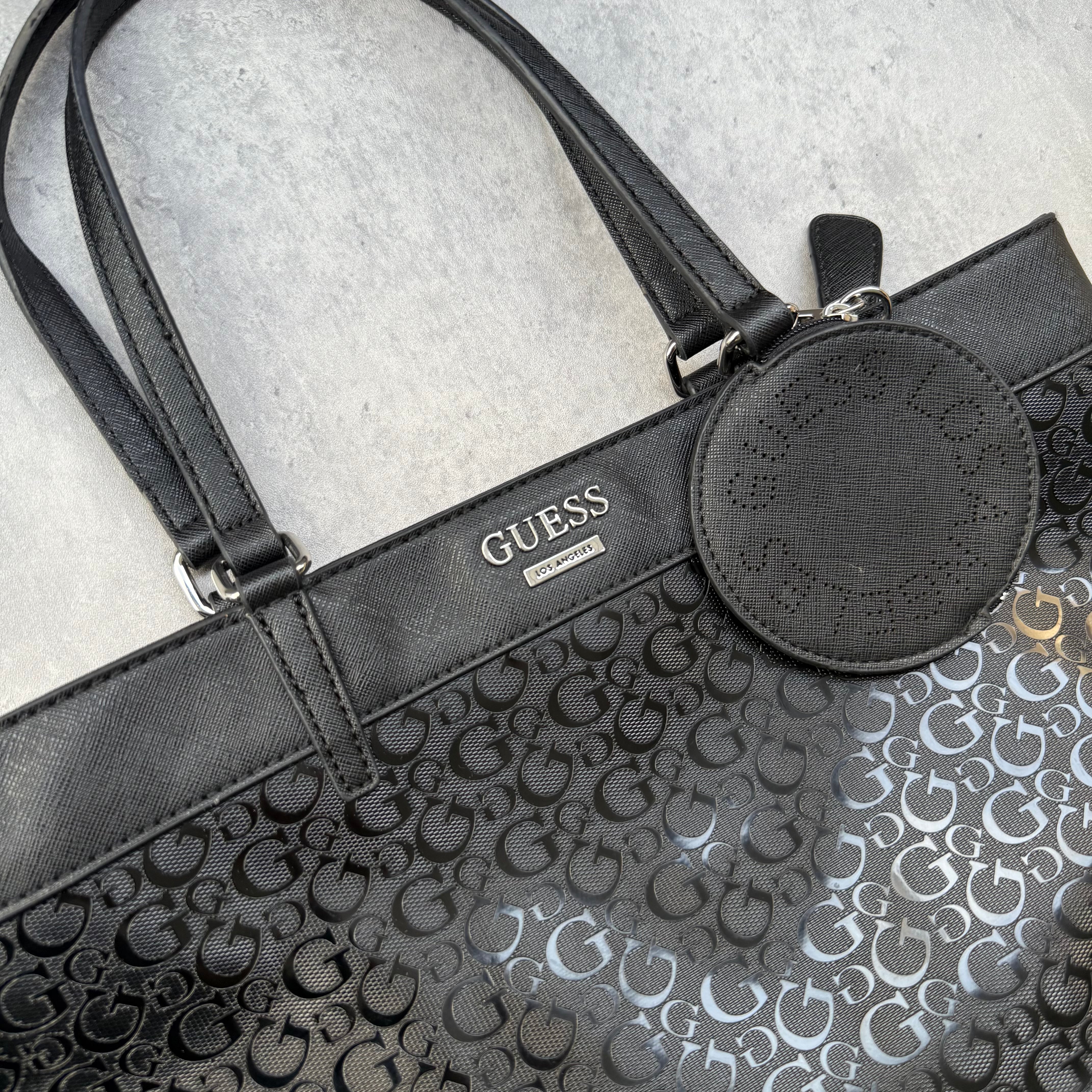 Guess Monogram Print Carryall Tote Bag in glossy black with logo charm and beige interior lining