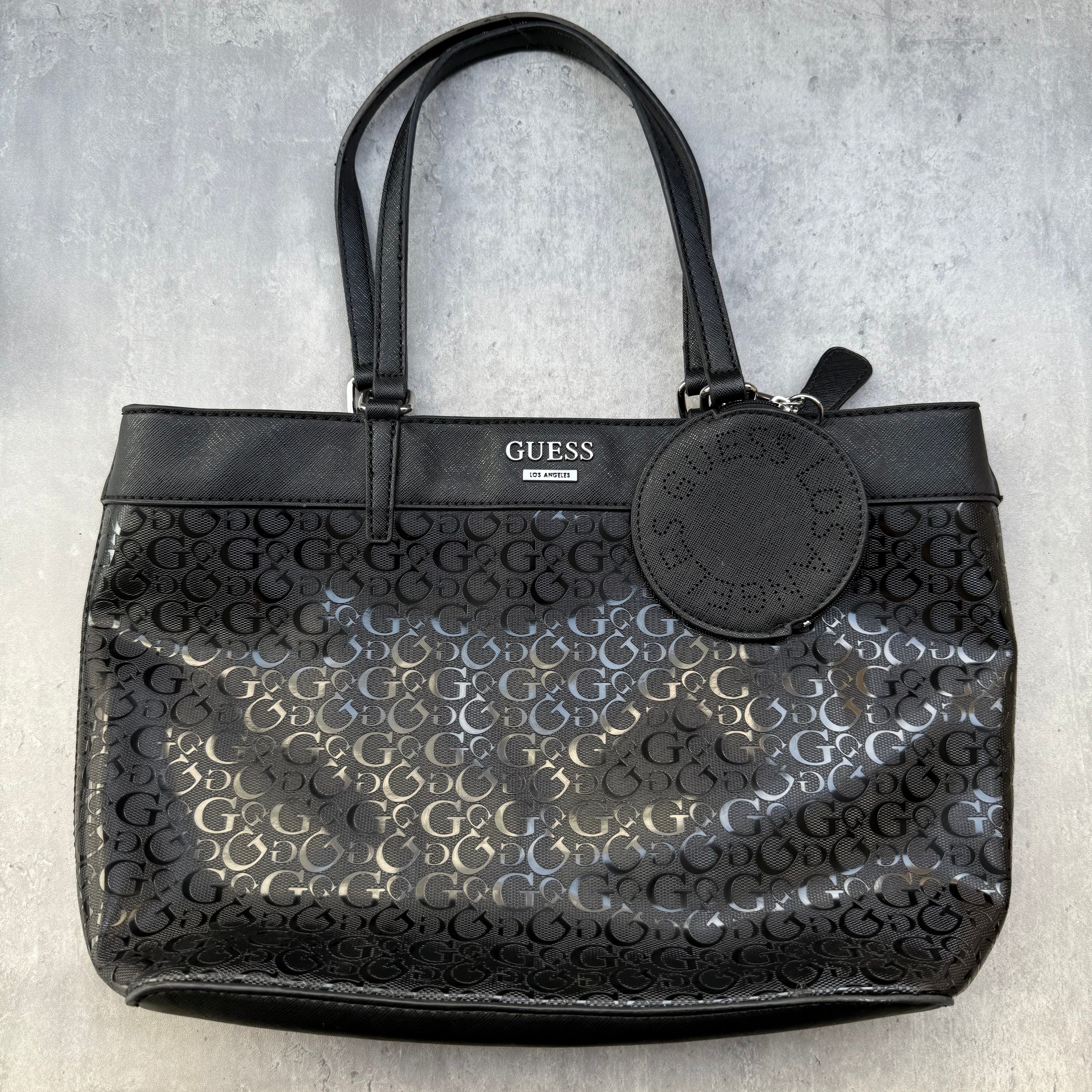 Guess Monogram Print Carryall Tote Bag in glossy black with logo charm and beige interior lining