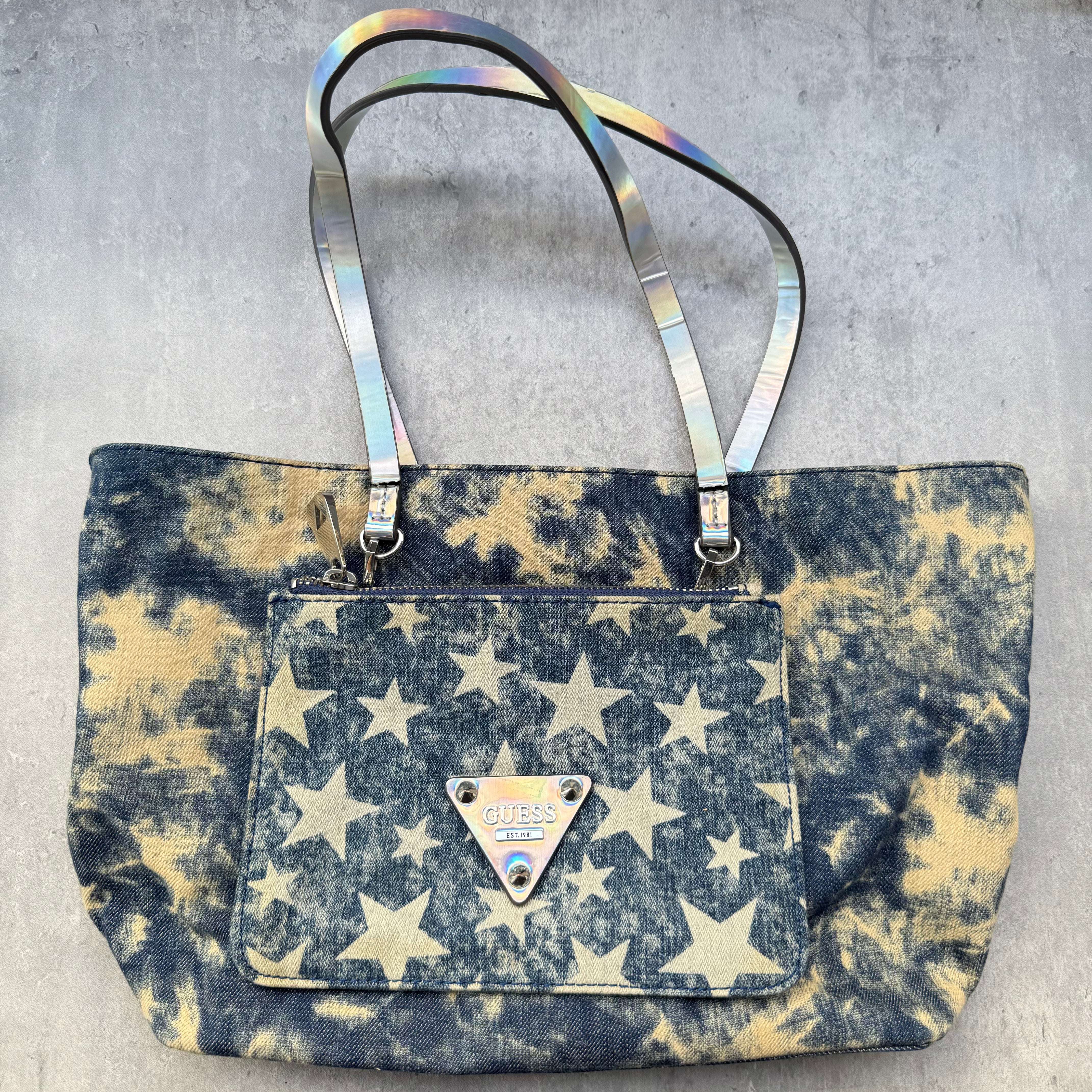 Guess Y2K Blue Denim Tote Bag with bleached star print, iridescent straps, red interior, and front Guess logo plaque.