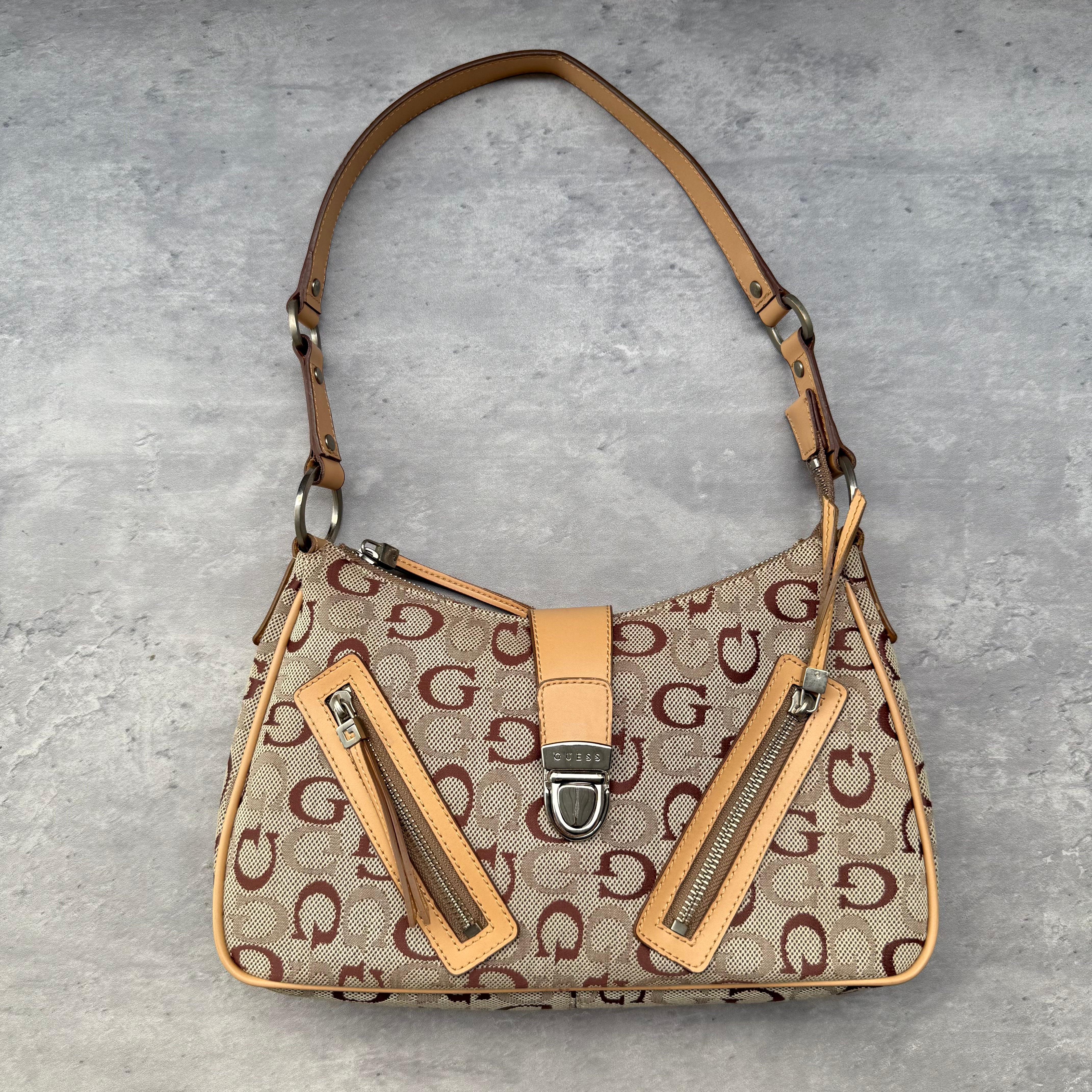 Guess Y2K G Monogram Shoulder Bag in beige canvas with tan leather trim, silver-tone clasp, and dual zipper accents.