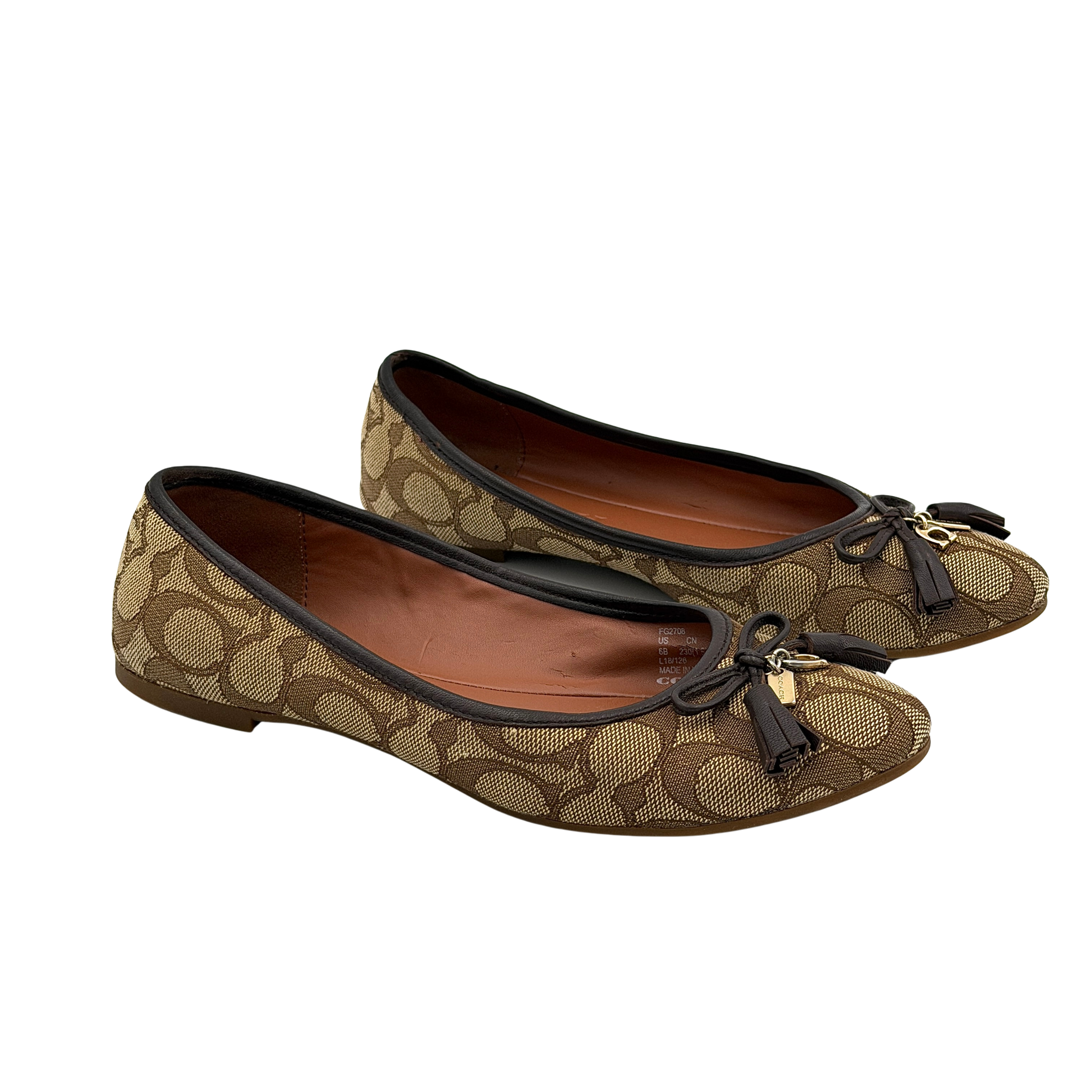 Coach Signature Bennie Jacqueline ballet flats in beige canvas with brown leather trims, shown side by side with tassel and gold charm details.