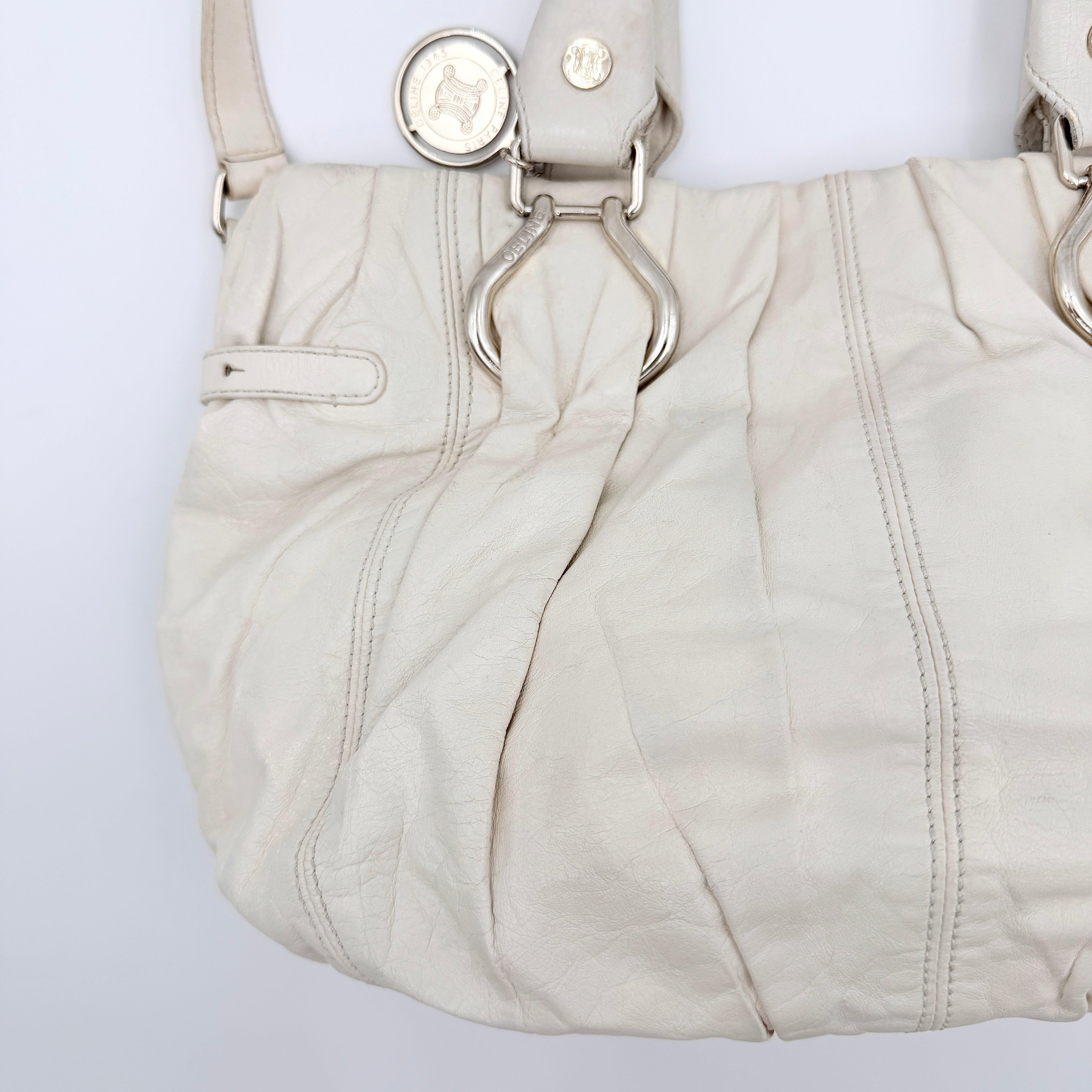 Celine 2Way Leather Shoulder Bag in white leather with architectural silver hardware, top handles, and an adjustable shoulder strap.