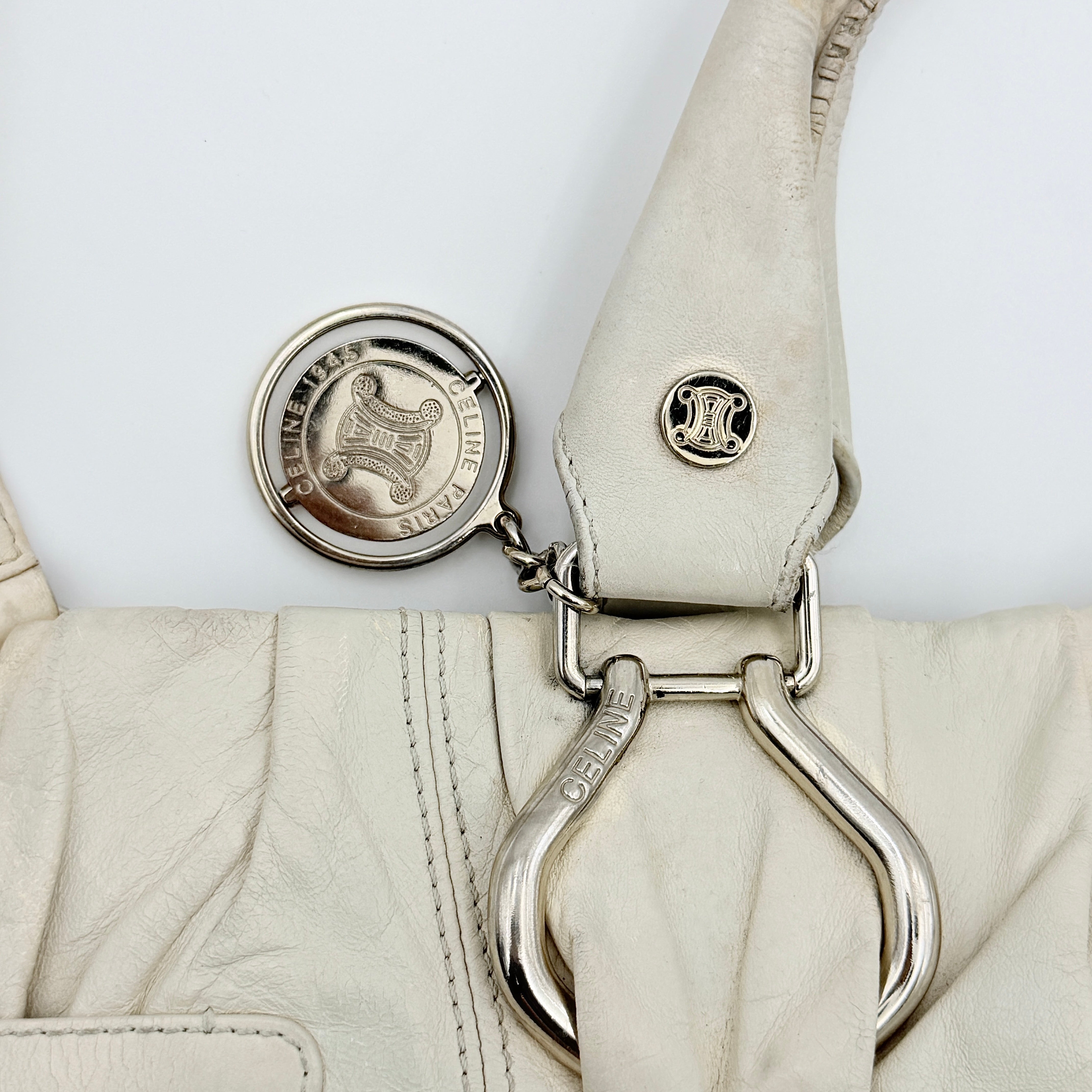 Celine 2Way Leather Shoulder Bag in white leather with architectural silver hardware, top handles, and an adjustable shoulder strap.