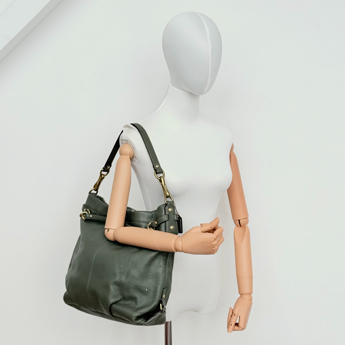 Coach Brooke Large Hobo Shoulder Bag in olive green pebbled leather with brass hardware, shown on a white background.