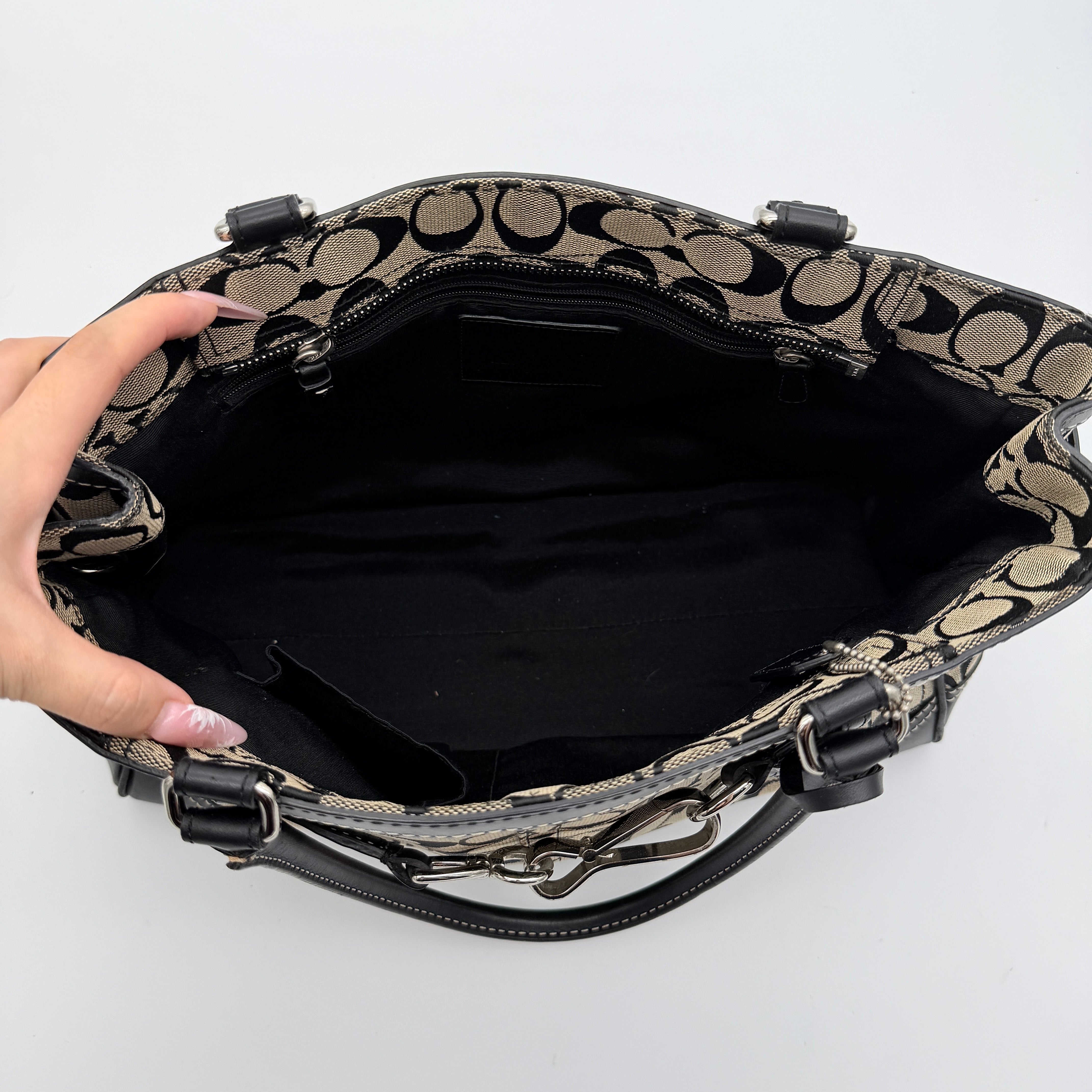 Coach Signature Hampton Clip Shoulder Bag in grey and black canvas with leather trim and silver-tone hardware, displayed with double handles.