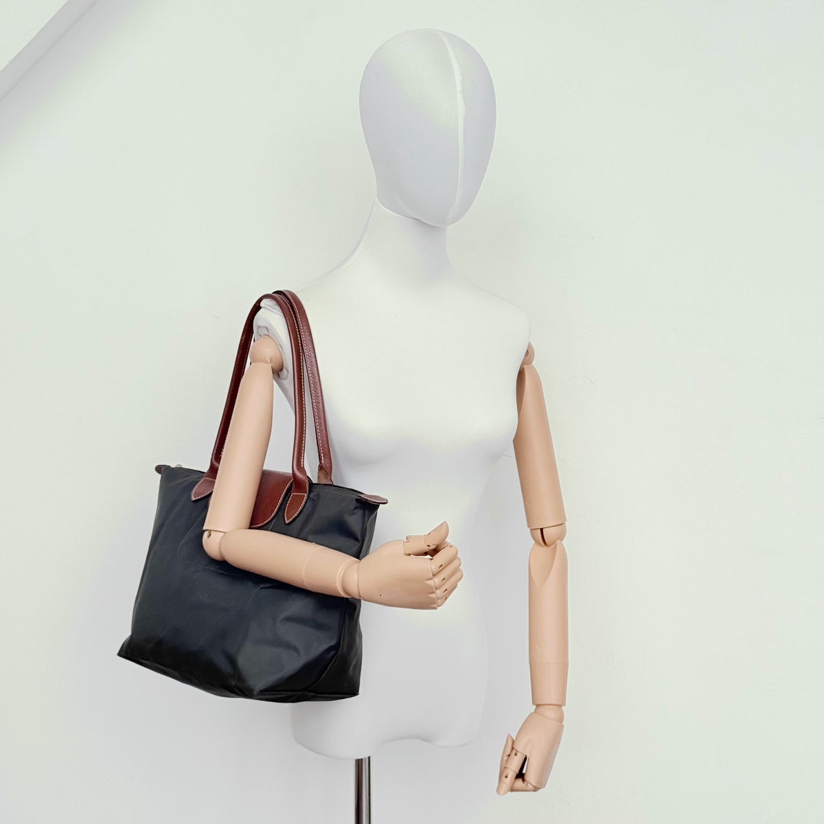 Longchamp Le Pliage Original Tote Bag in grey nylon with brown leather handles and flap, displayed against a white background.