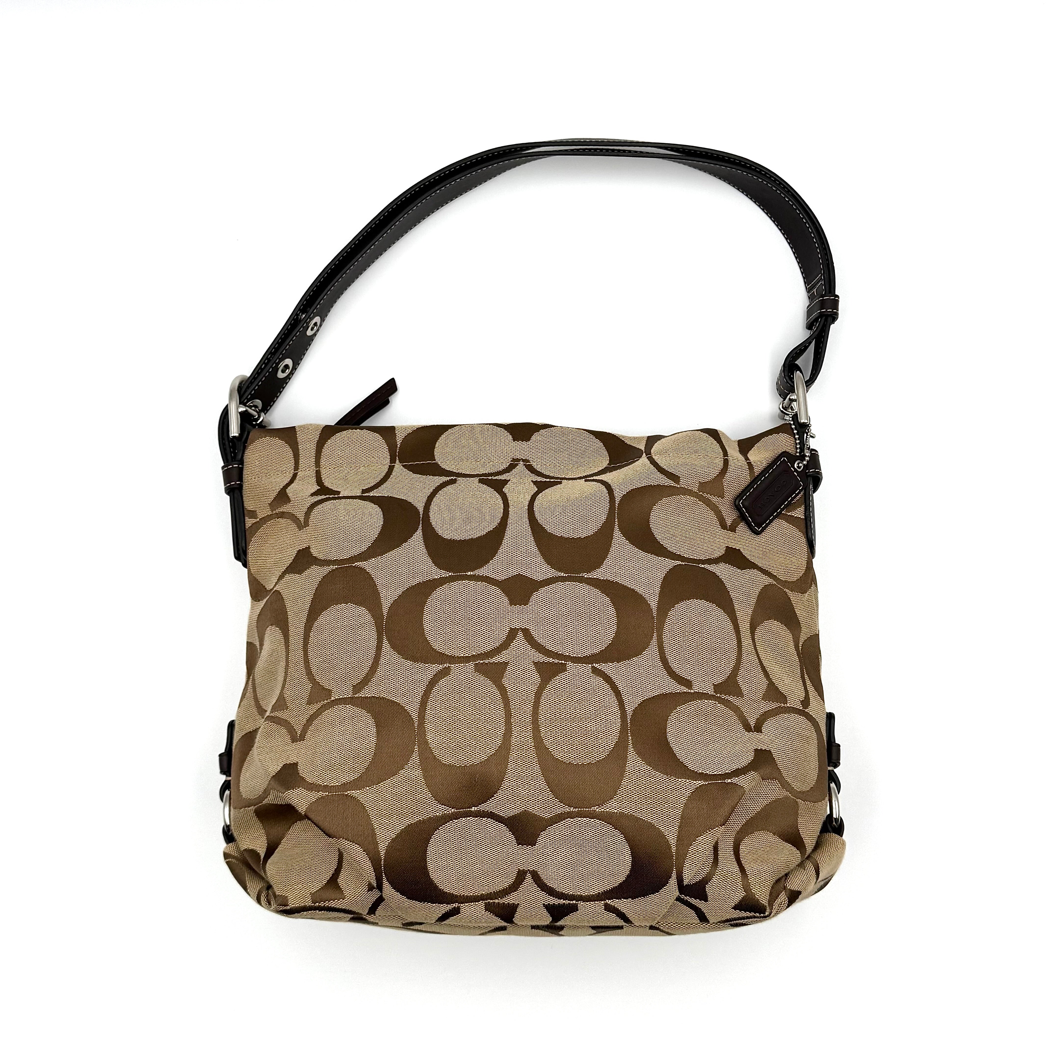 Coach beige and brown signature canvas hobo shoulder bag with black leather strap and silver hardware shown on a white background.