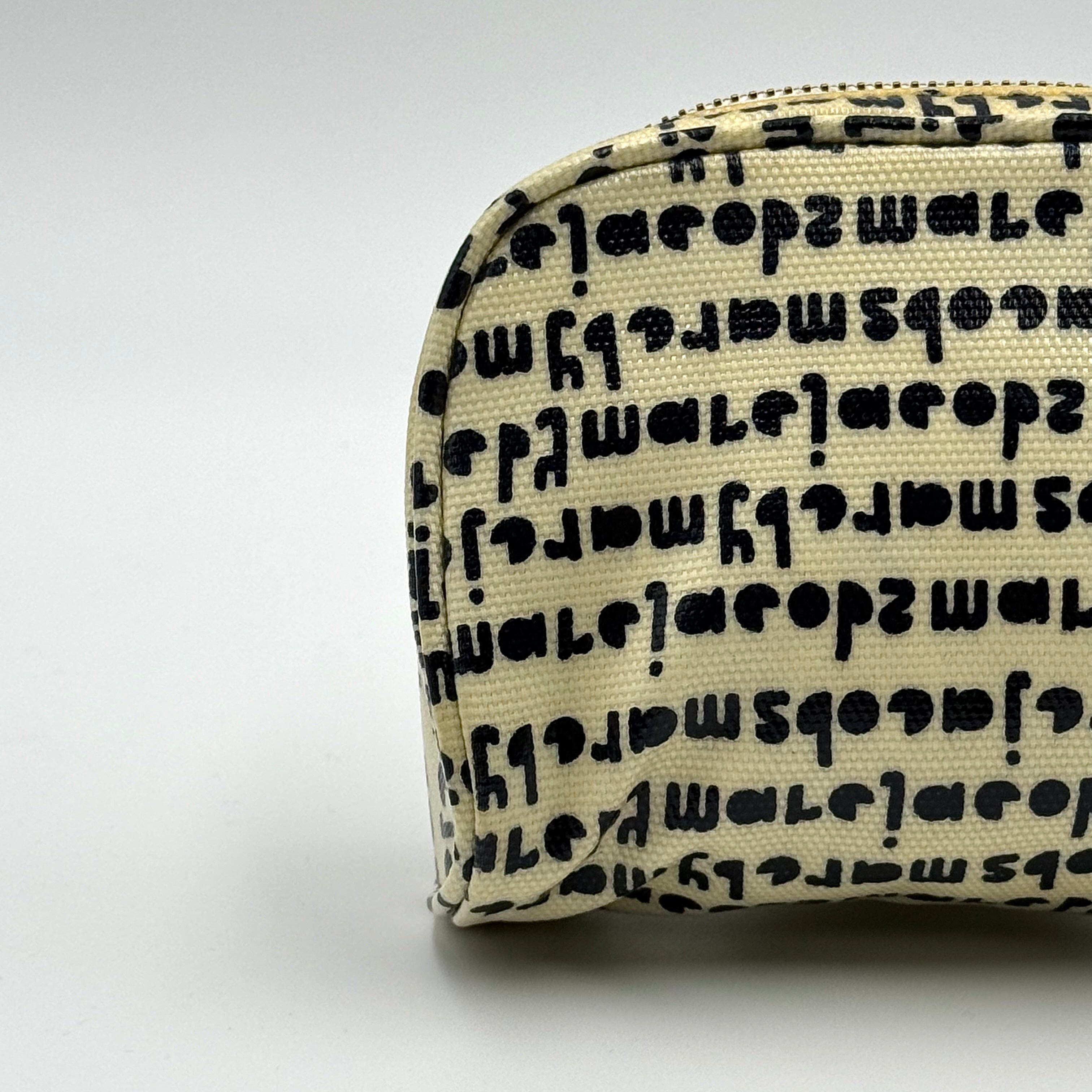 Marc Jacobs dome-shaped cosmetic case in cream coated canvas with navy script and gold hardware.