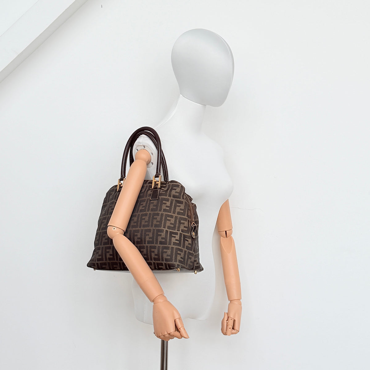 Fendi Zucca FF Monogram Handbag in brown canvas with leather handles and gold hardware, displayed against a clean background.