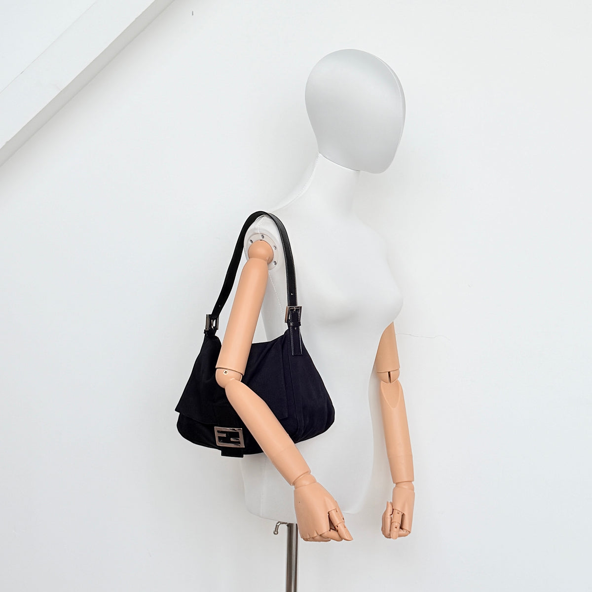 Fendi Mamma Baguette Shoulder Bag in black fabric with silver FF buckle and leather strap, photographed on a white backdrop.