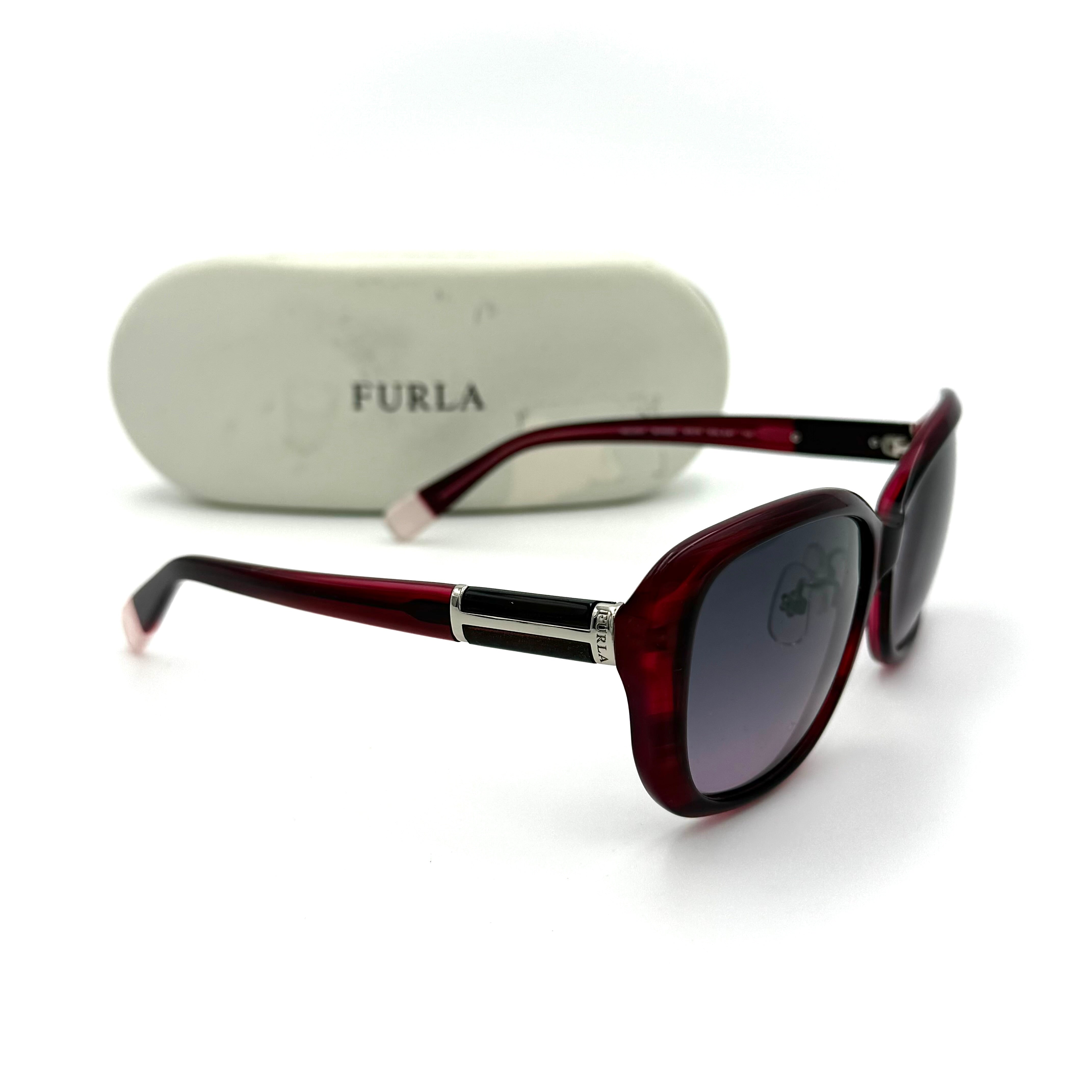 Furla SU4925J sunglasses in dark red acetate with butterfly-shaped frames, silver-tone hardware, and gradient lenses, presented alongside a Furla hard case.