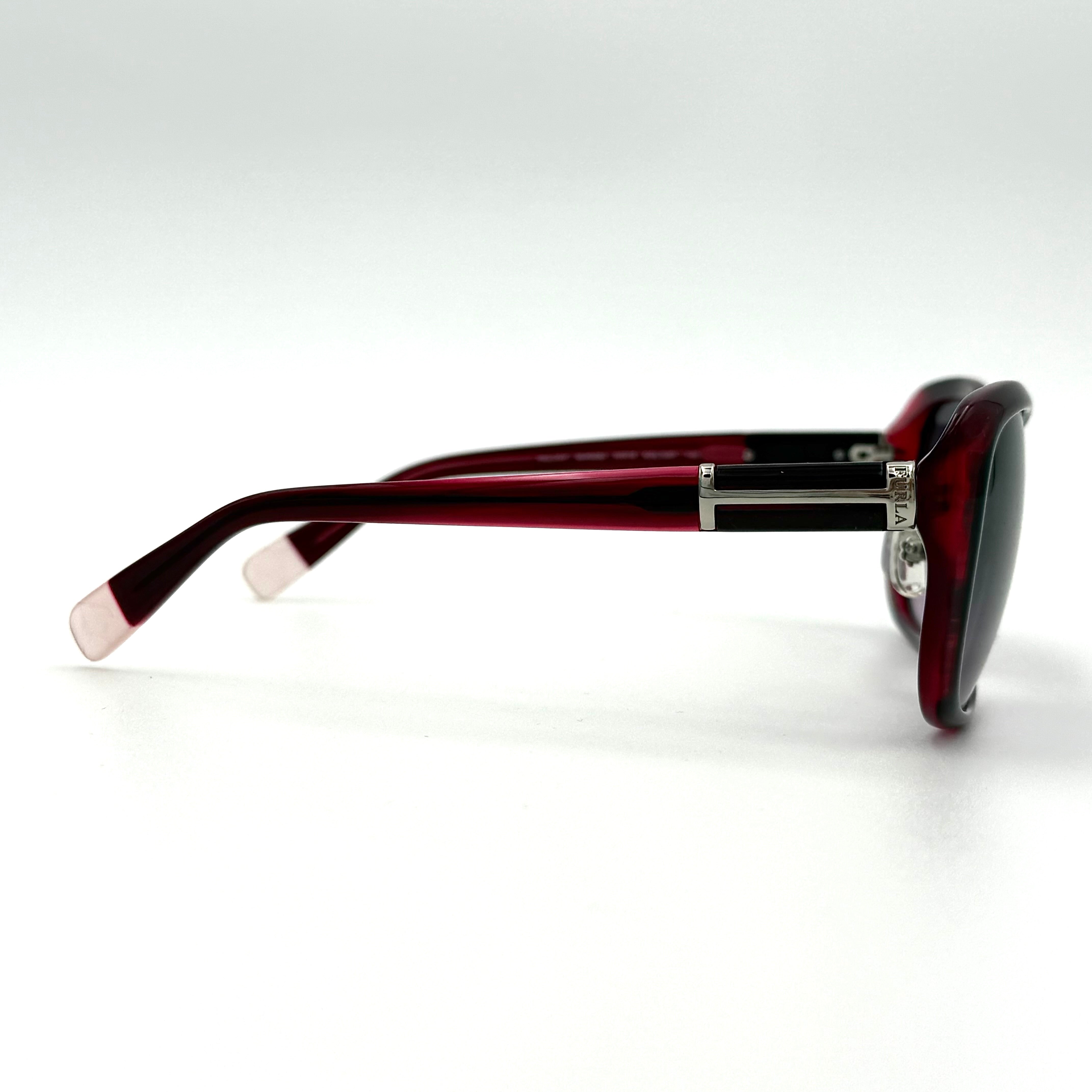 Furla SU4925J sunglasses in dark red acetate with butterfly-shaped frames, silver-tone hardware, and gradient lenses, presented alongside a Furla hard case.