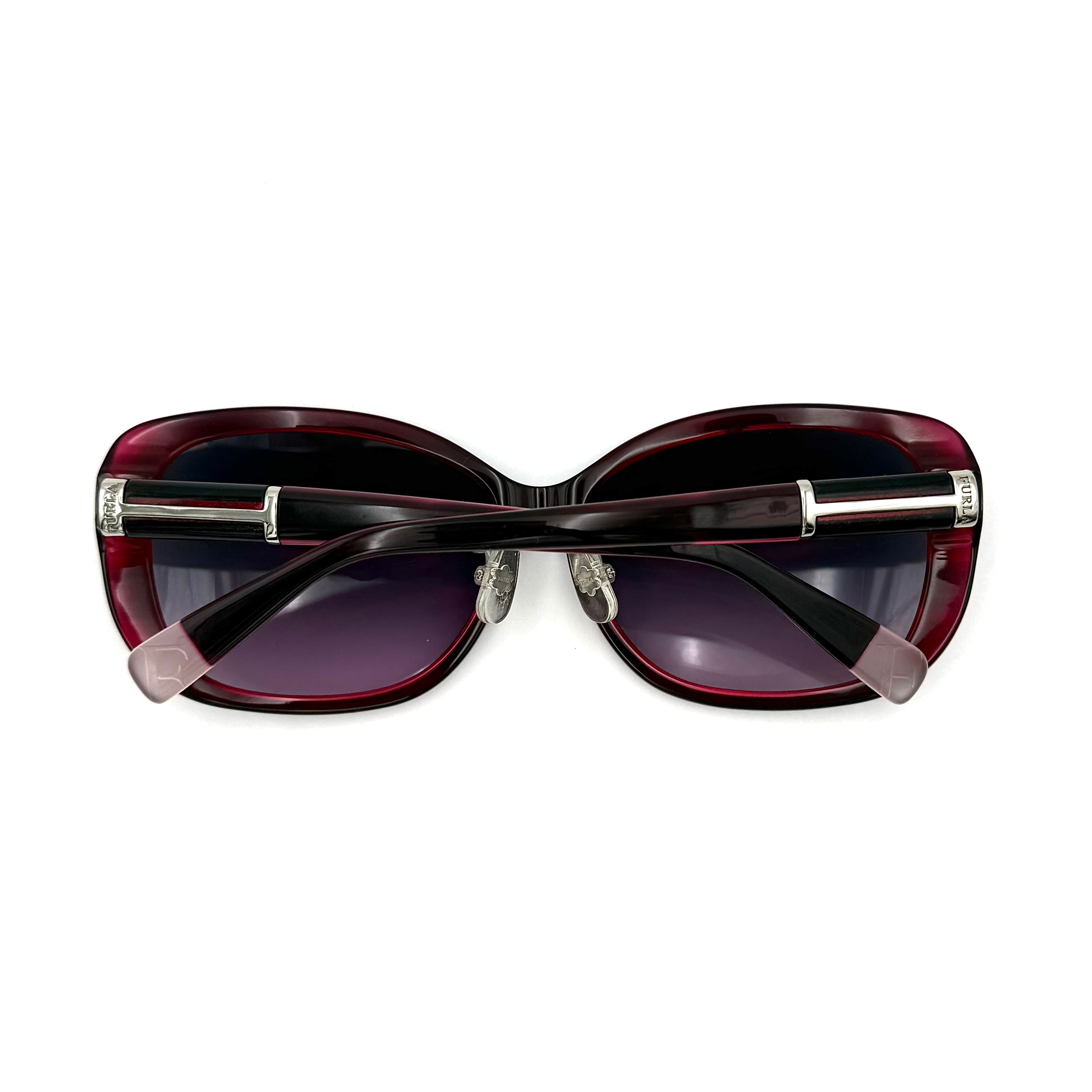 Furla SU4925J sunglasses in dark red acetate with butterfly-shaped frames, silver-tone hardware, and gradient lenses, presented alongside a Furla hard case.