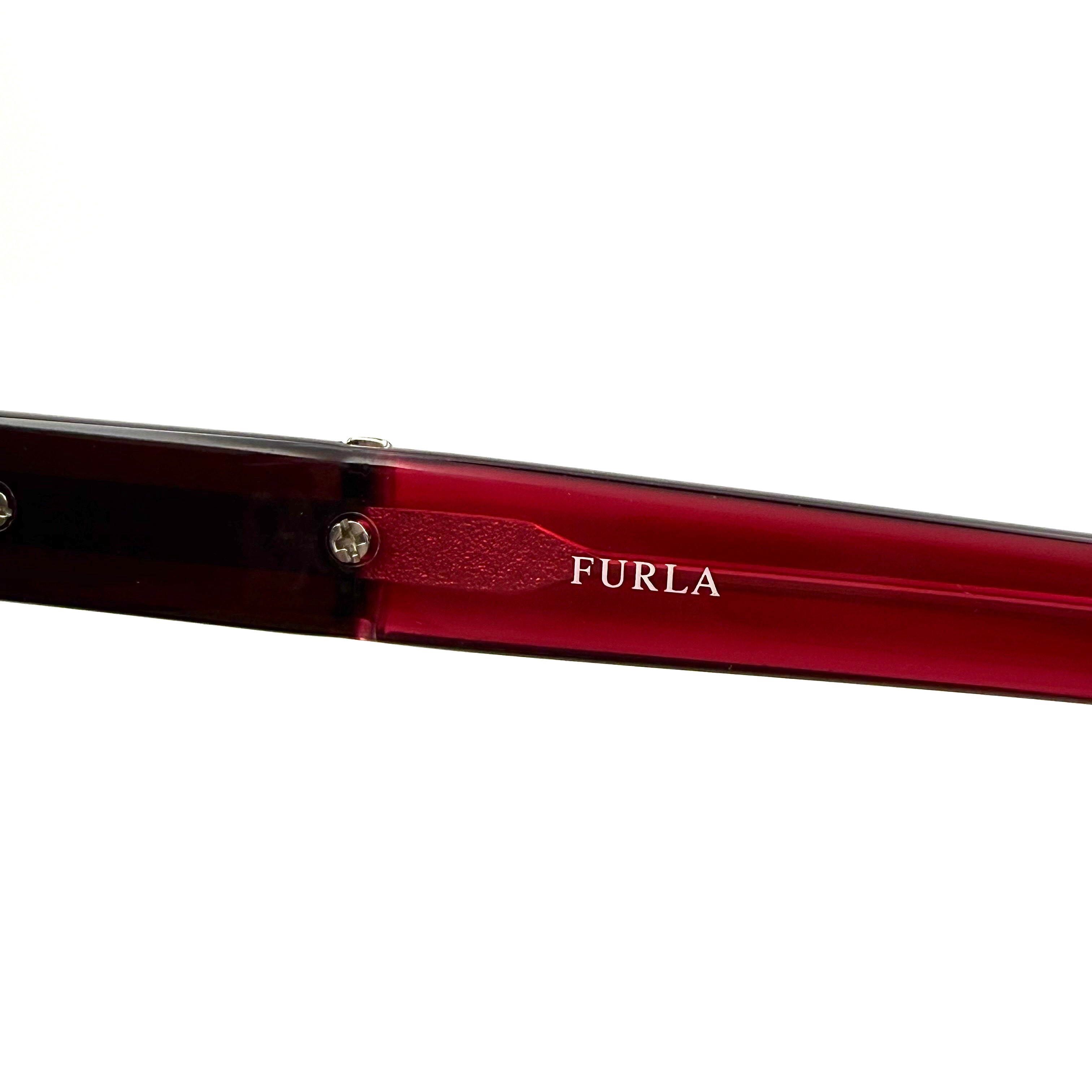 Furla SU4925J sunglasses in dark red acetate with butterfly-shaped frames, silver-tone hardware, and gradient lenses, presented alongside a Furla hard case.