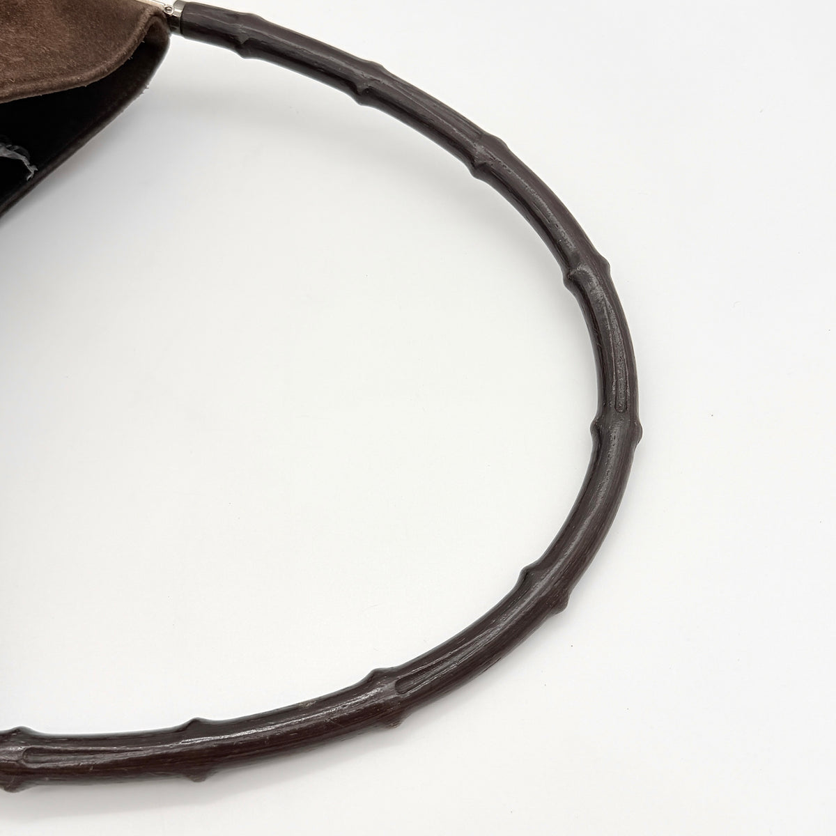 Gucci Bamboo Shoulder Bag in brown suede with a sculpted bamboo handle, photographed on a white background.