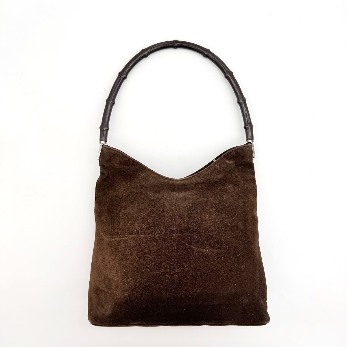 Gucci Bamboo Shoulder Bag in brown suede with a sculpted bamboo handle, photographed on a white background.