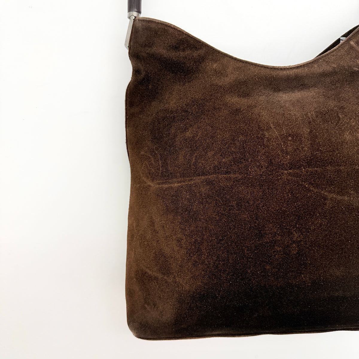 Gucci Bamboo Shoulder Bag in brown suede with a sculpted bamboo handle, photographed on a white background.