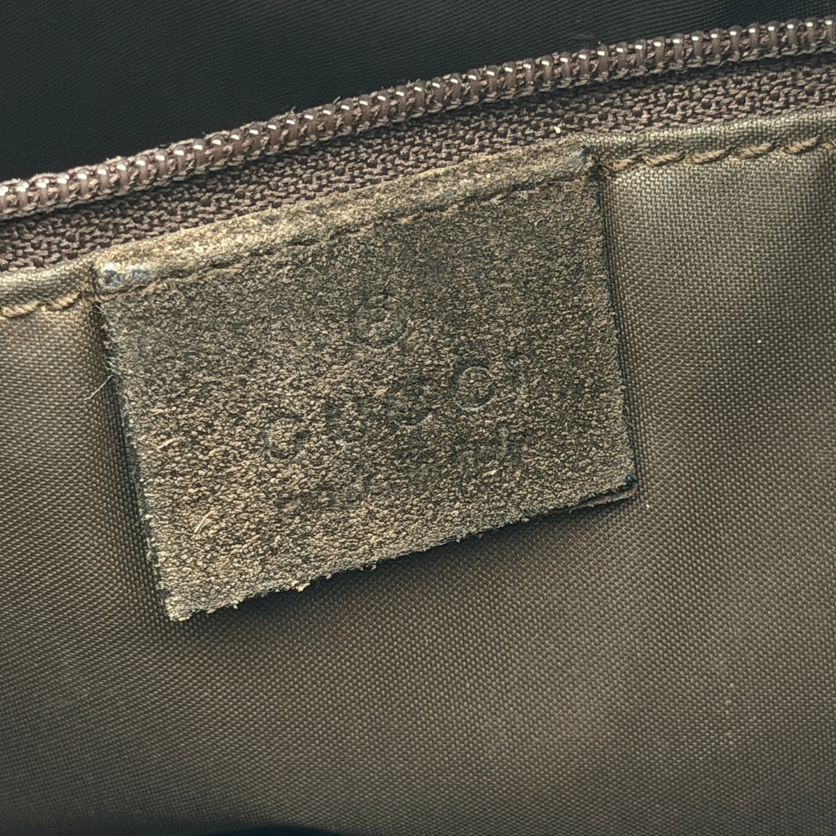 Gucci Bamboo Shoulder Bag in brown suede with a sculpted bamboo handle, photographed on a white background.