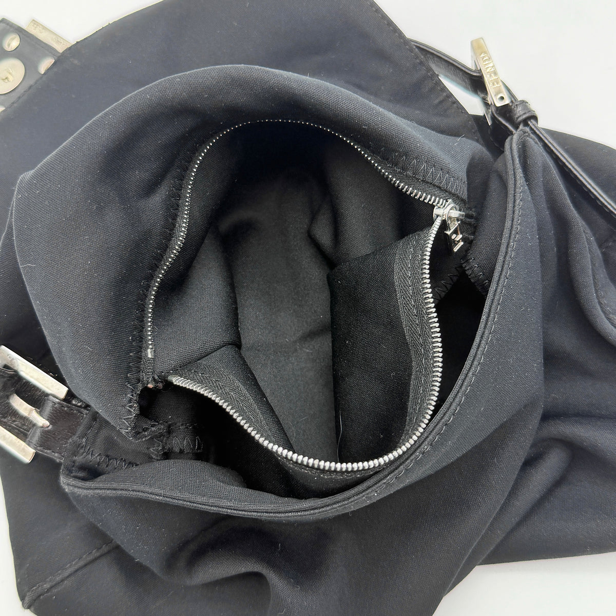 Fendi Mamma Baguette Shoulder Bag in black fabric with silver FF buckle and leather strap, photographed on a white backdrop.