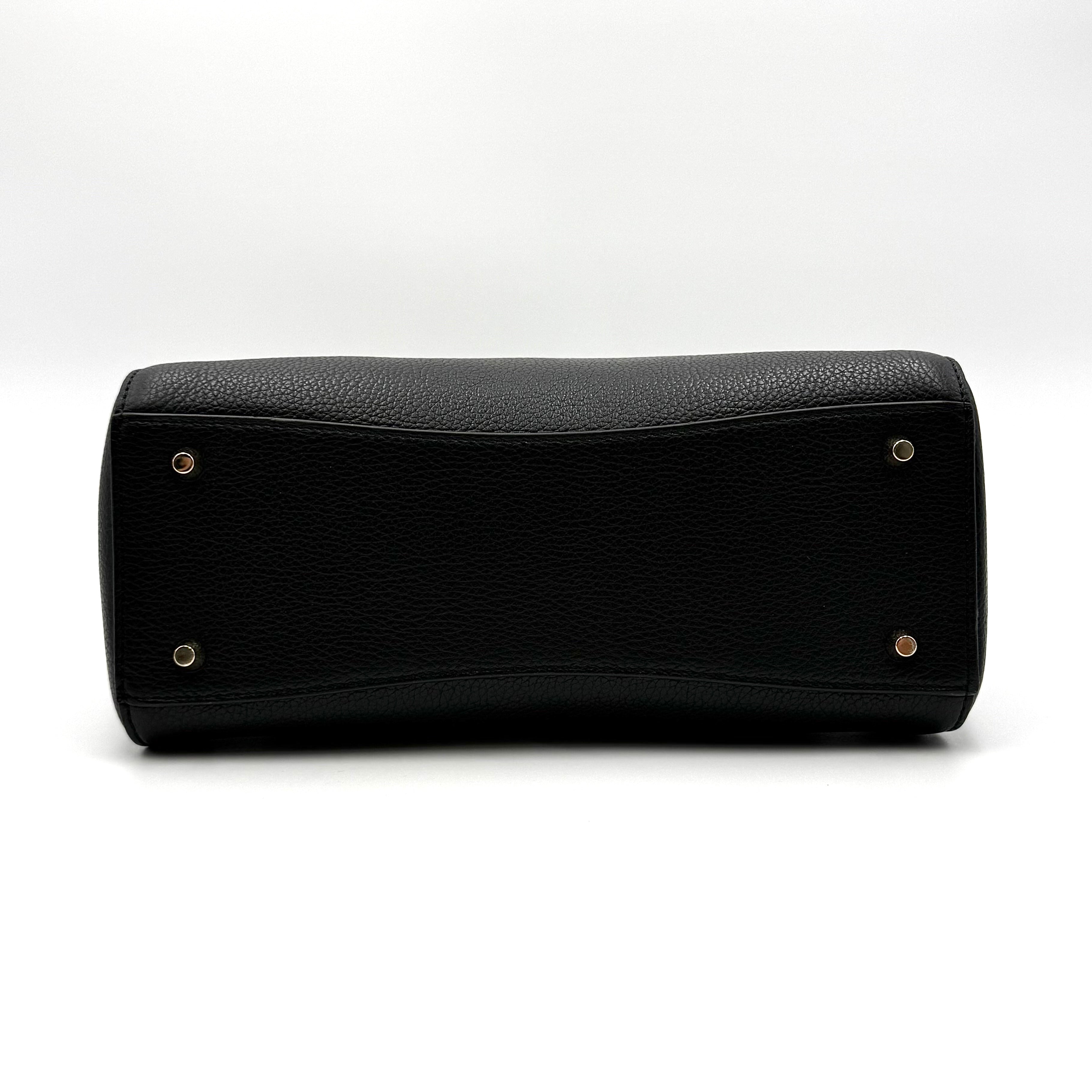 Front view of the Furla Tessa black leather satchel with gold-tone Furla charm and structured silhouette.