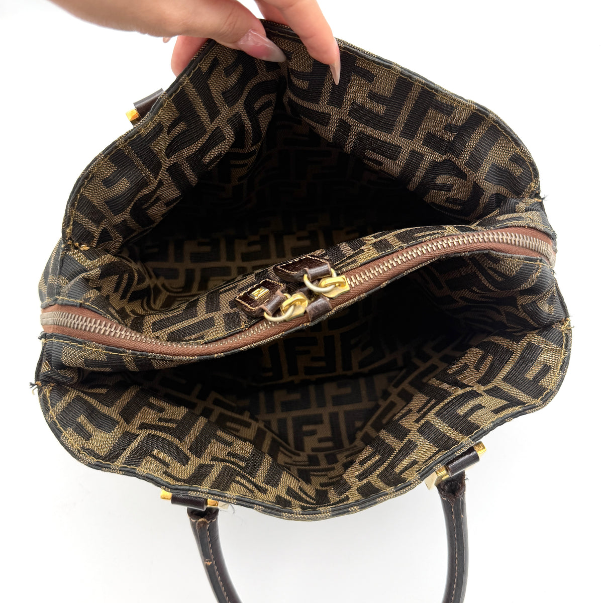 Fendi Zucca FF Monogram Handbag in brown canvas with leather handles and gold hardware, displayed against a clean background.